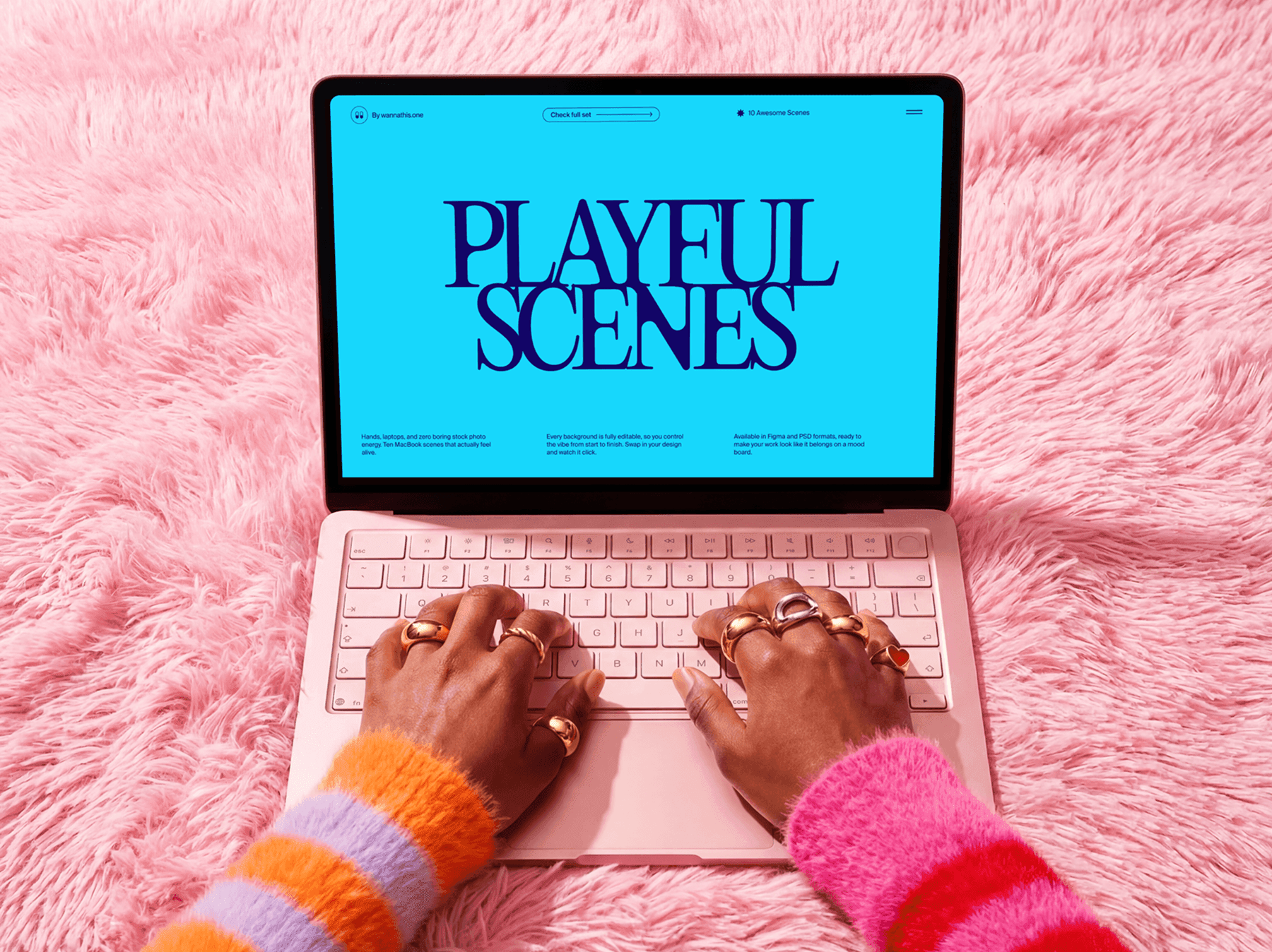 Hands typing on a MacBook placed on a soft textured surface