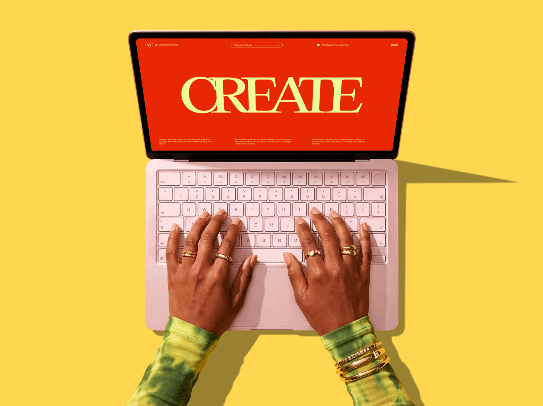 Top view of hands typing on a MacBook keyboard in a clean setup