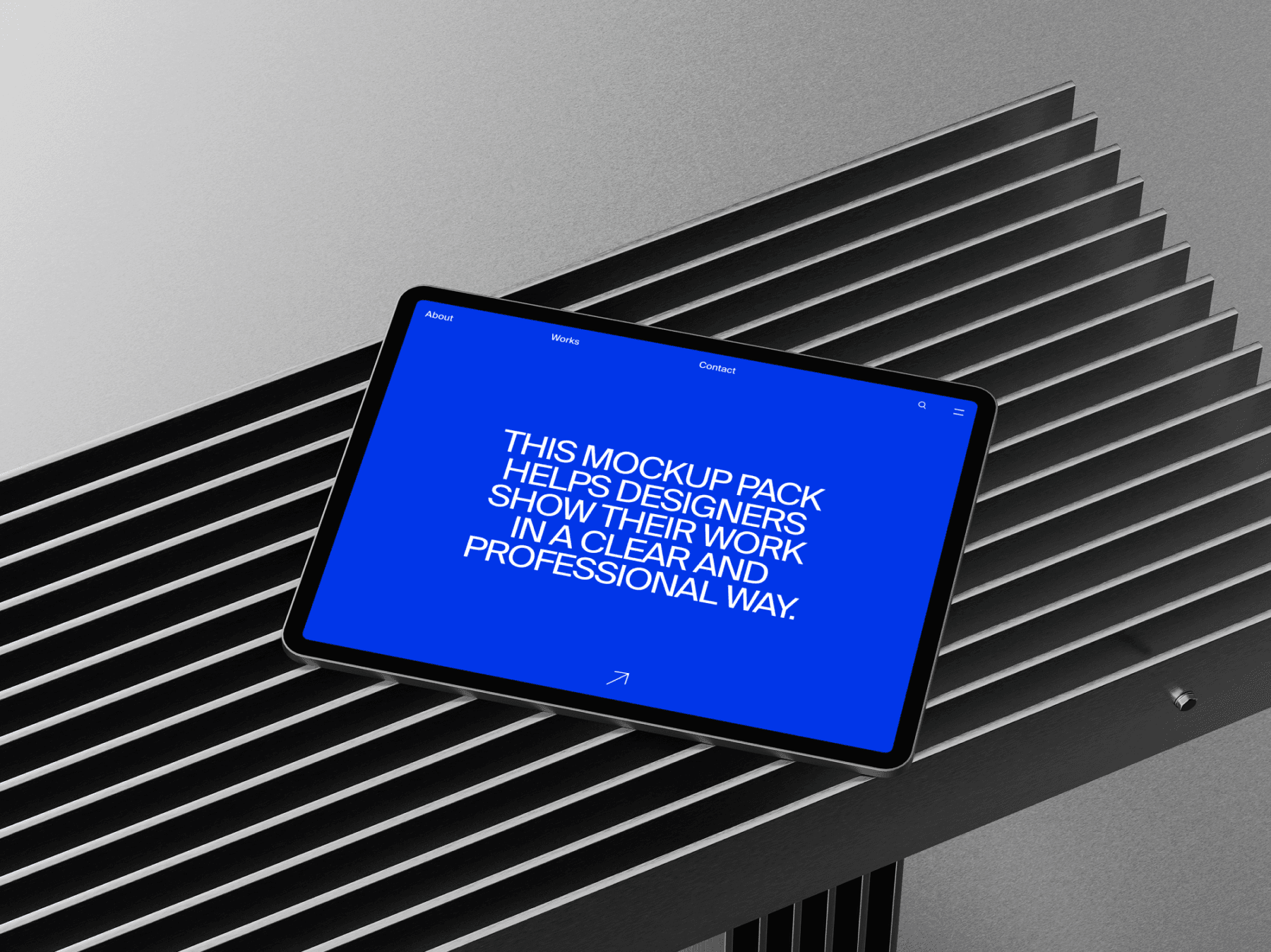 Tablet mockup positioned on a slatted metallic surface in studio light