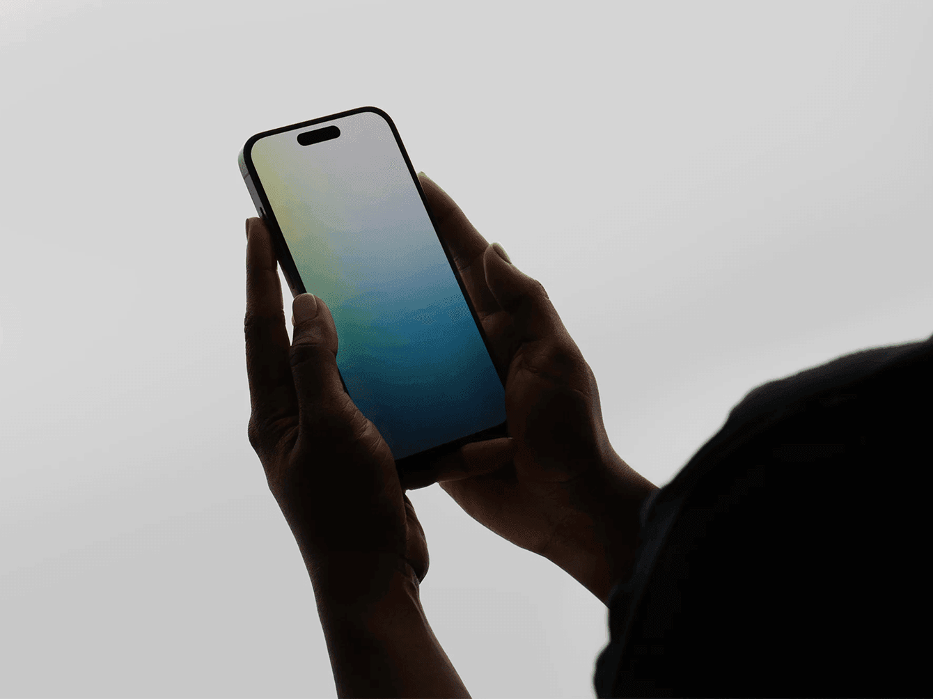 Minimal iPhone mockup in hands with gradient screen on light background