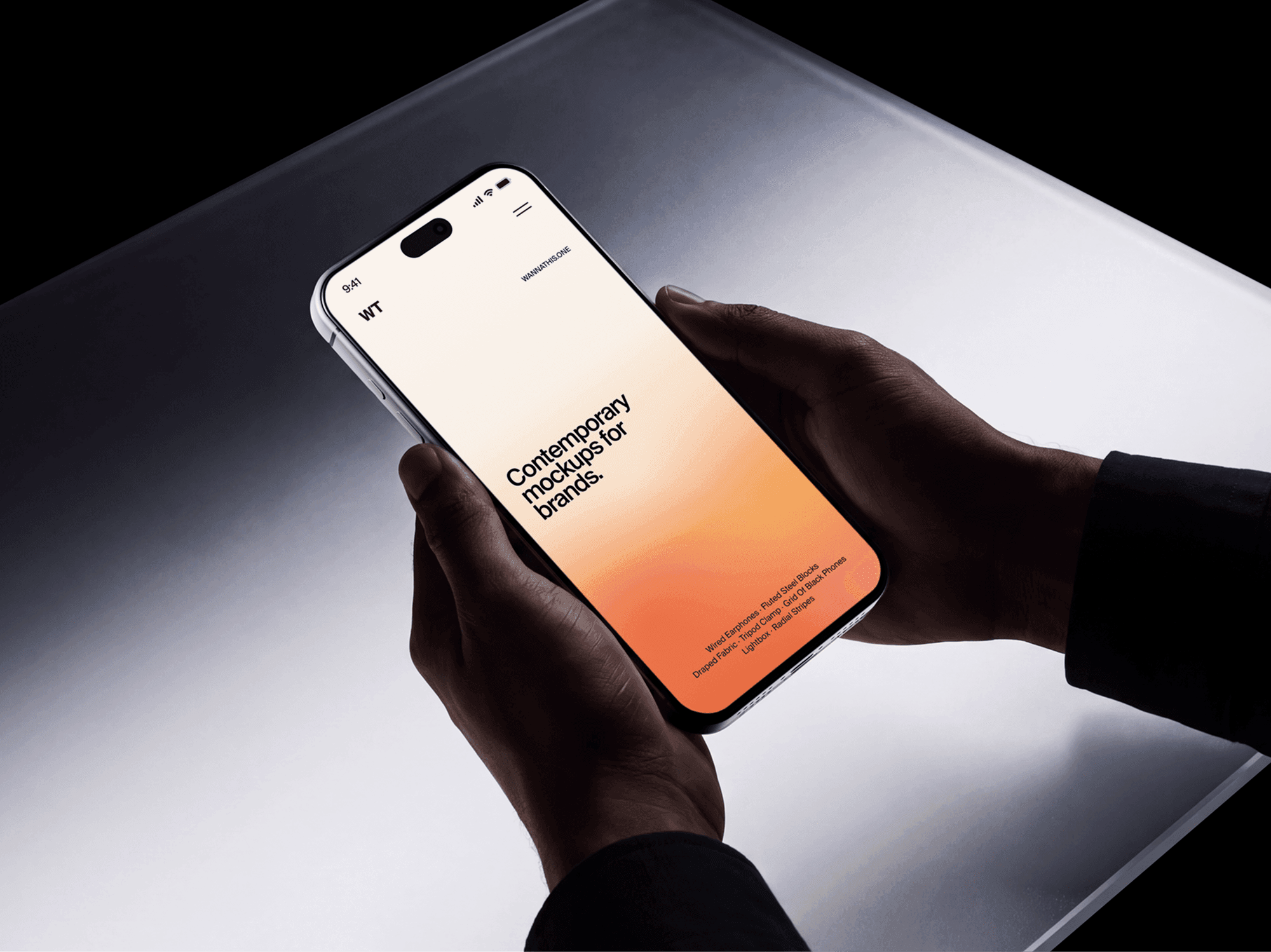 iPhone 18 Pro mockup held in two hands above a lit panel on a dark backdrop