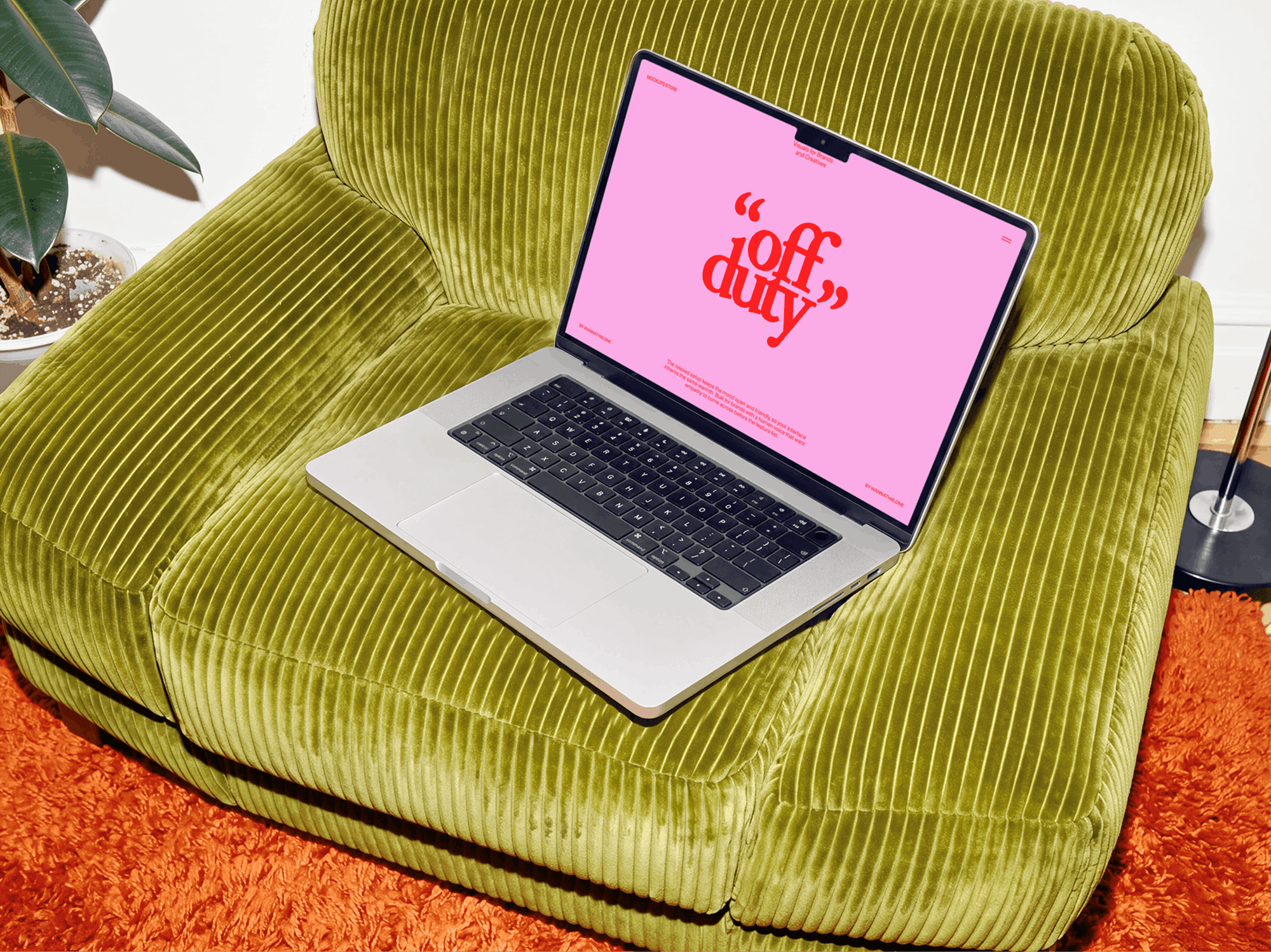 Open MacBook left on a soft lounge chair with the cushion dipping underneath