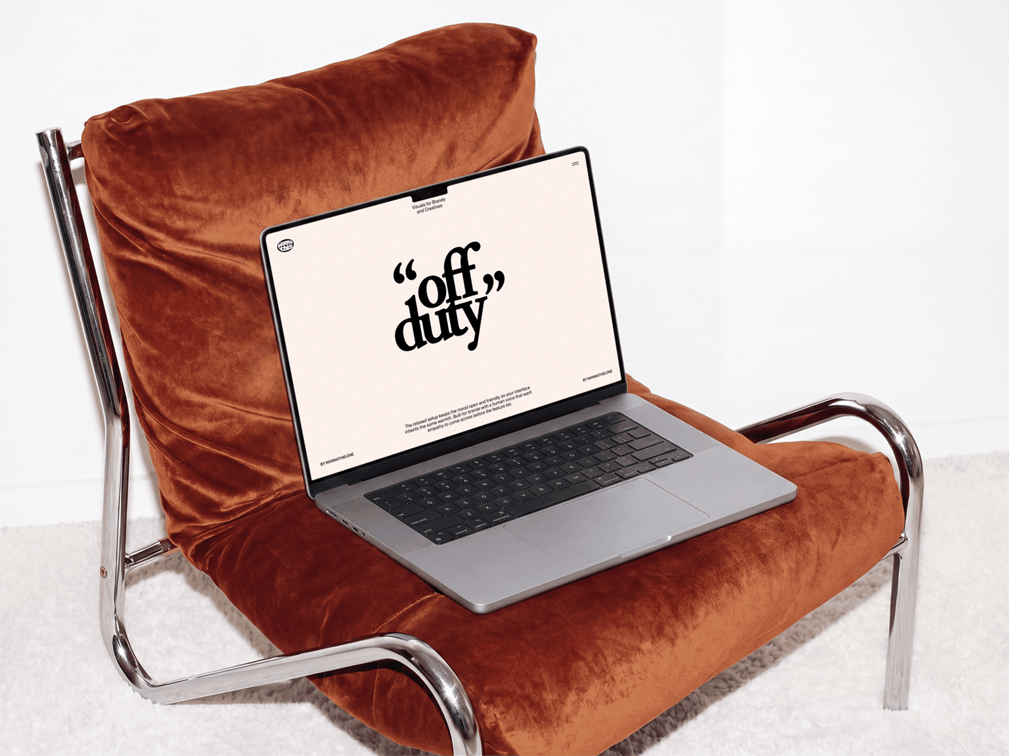Open MacBook resting on a chair built from a slim metal frame