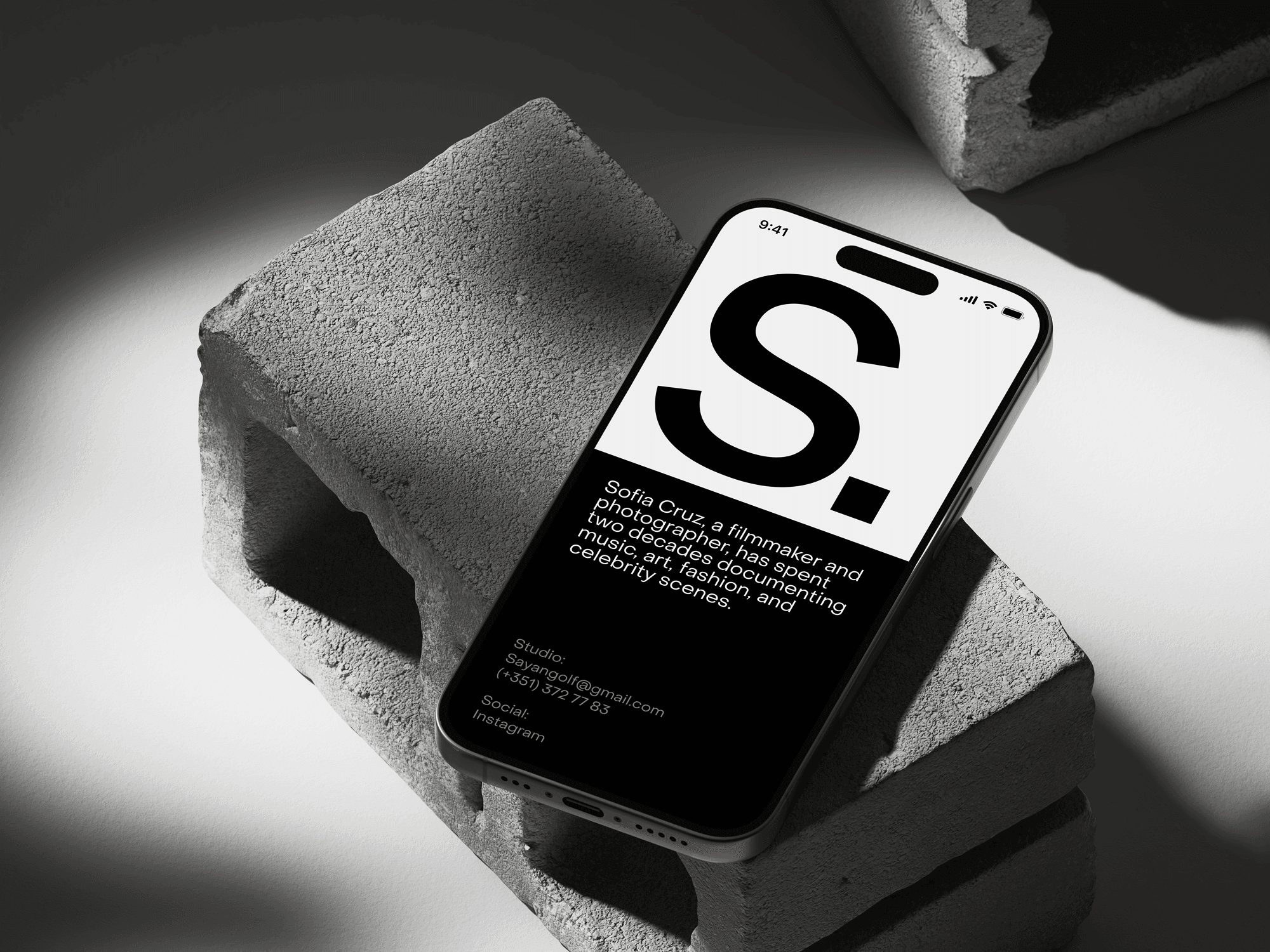 iPhone 15 Pro mockup on a textured rock with a moody lighting setup