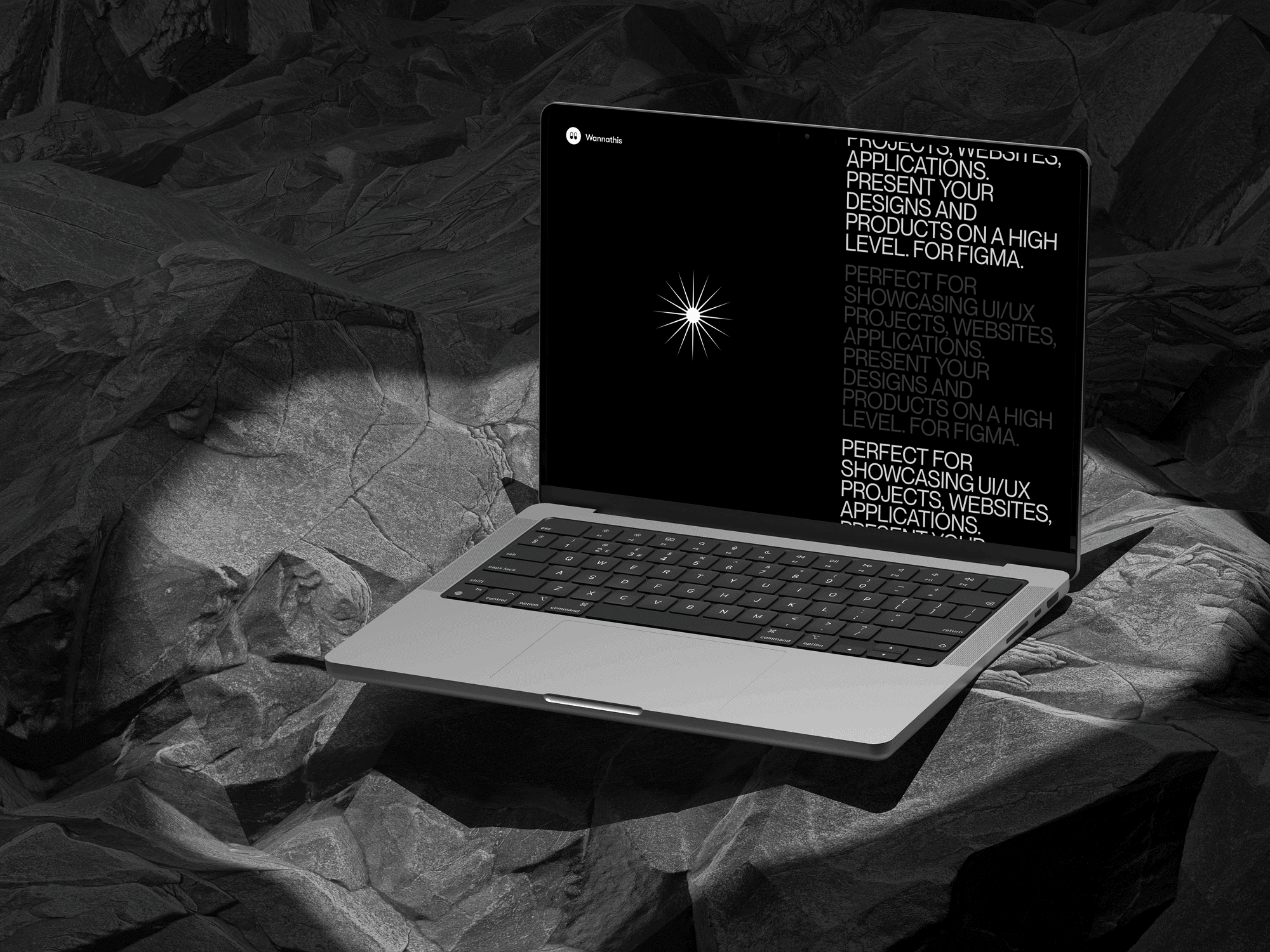 A MacBook Pro mockup placed on rough black rock textures.