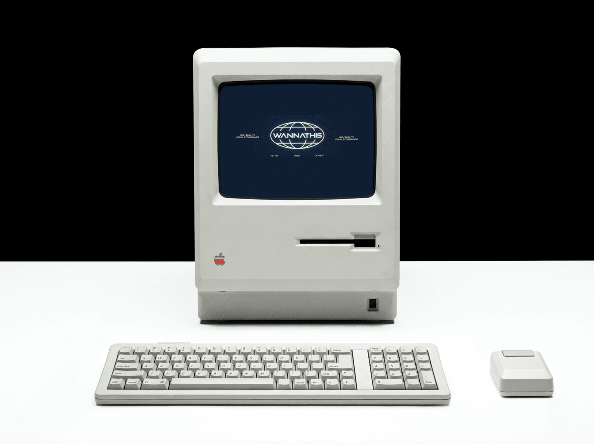 Boxy retro computer on a pale desk with a matching keyboard and squared mouse