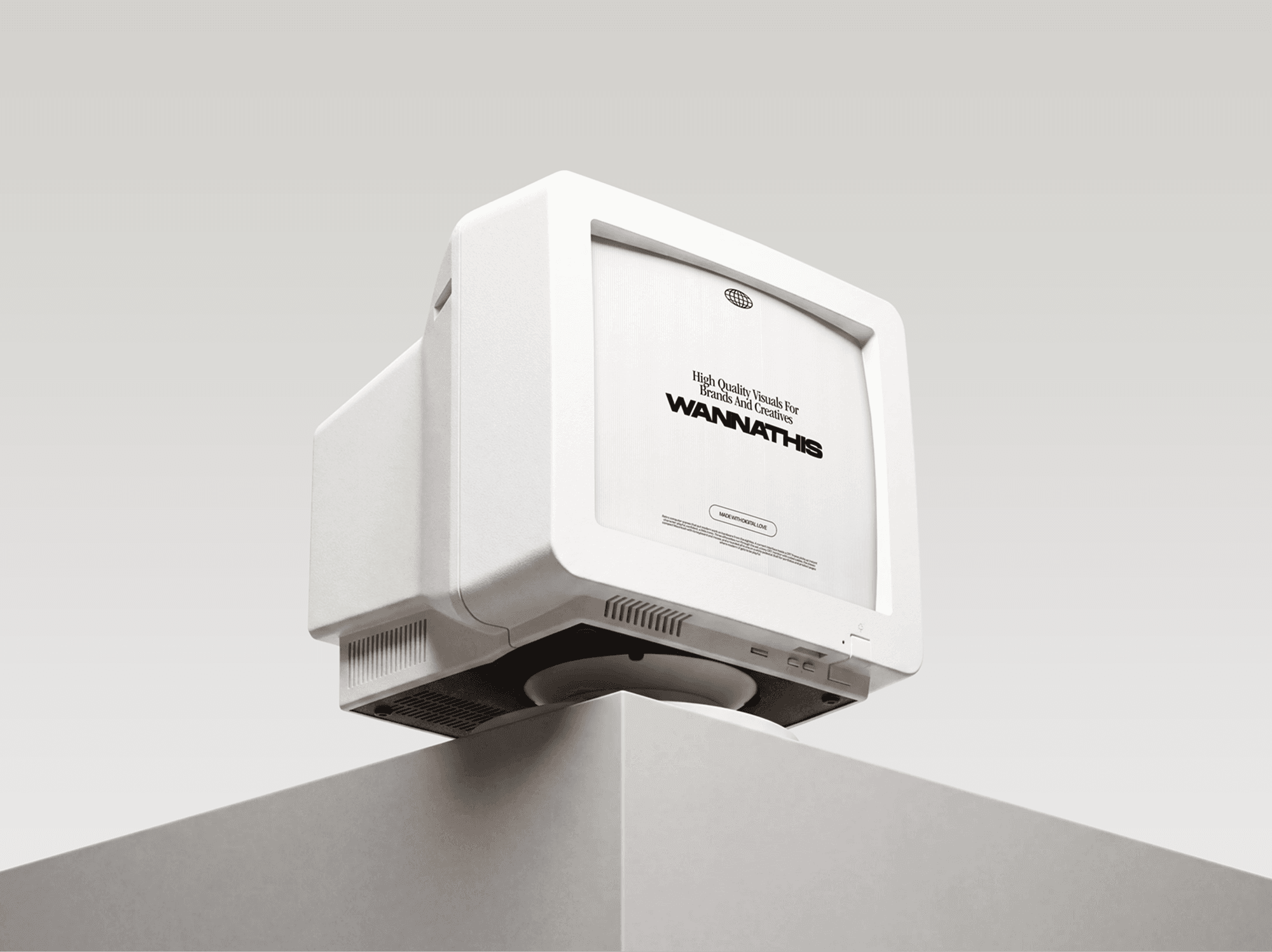 Beige CRT monitor tilted over the edge of a grey ledge seen from a low angle