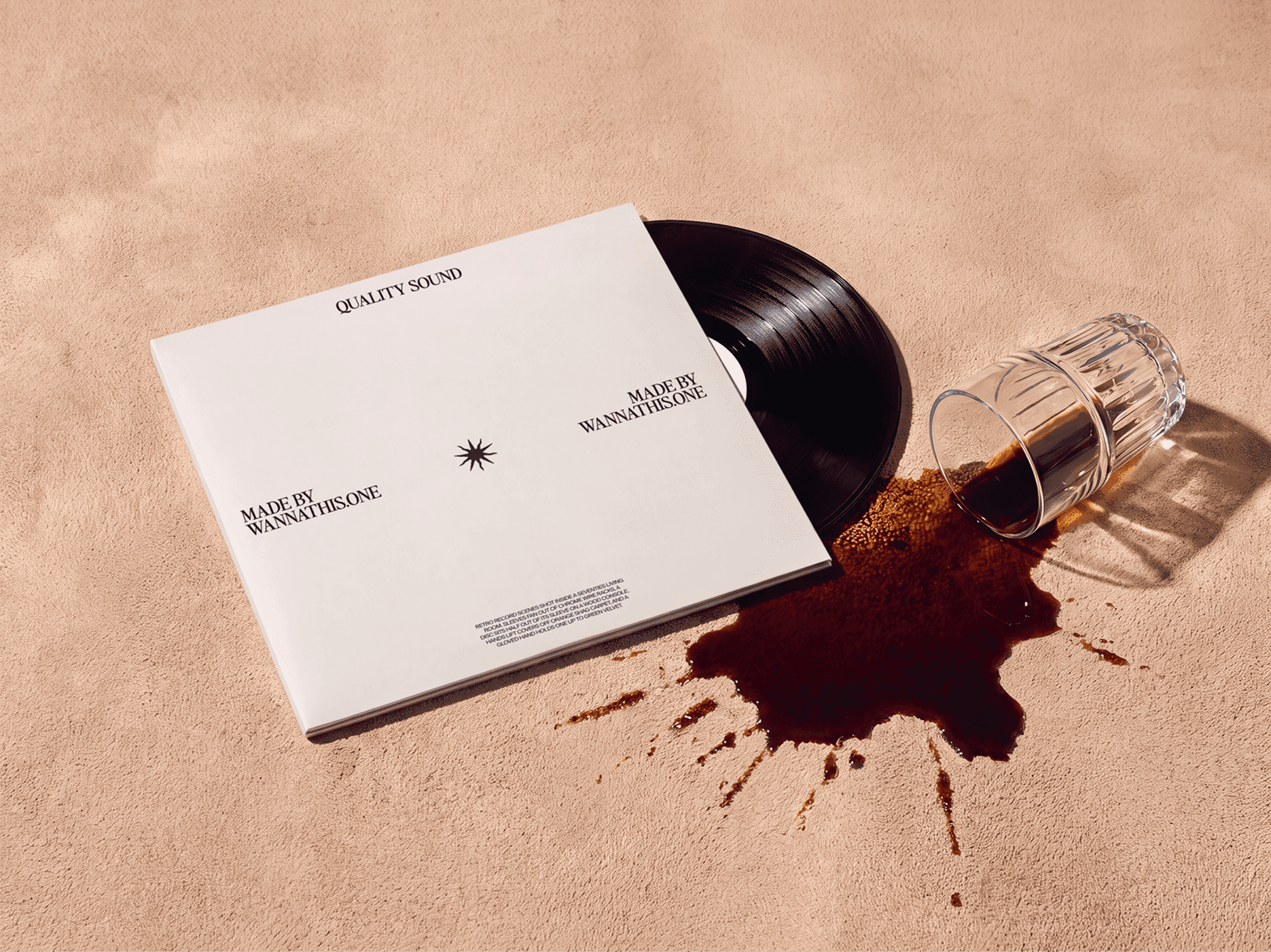 Vinyl record sleeve beside a tipped glass with drink spreading across the surface