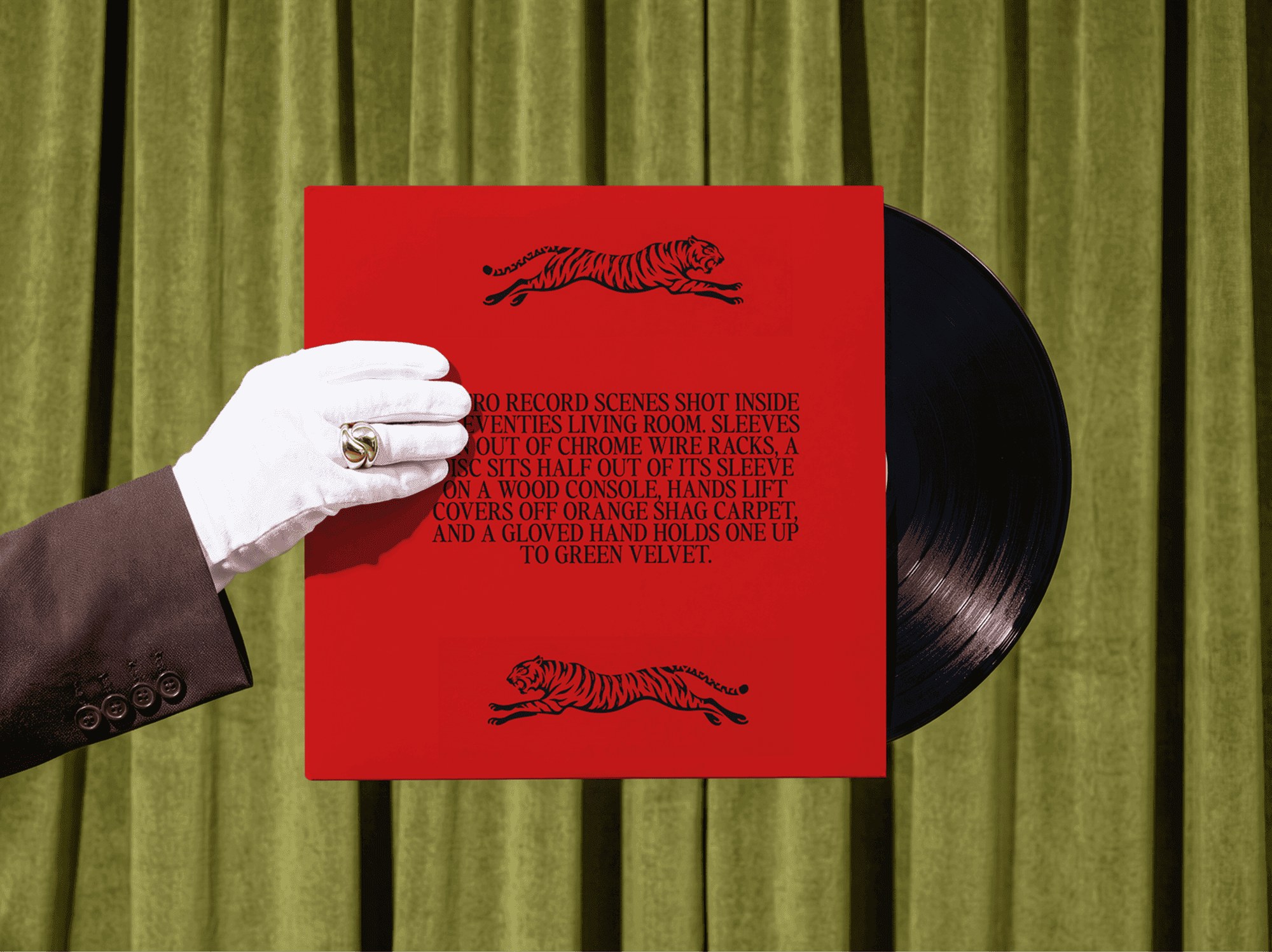 Gloved hand holding a vinyl record sleeve with the disc partly showing