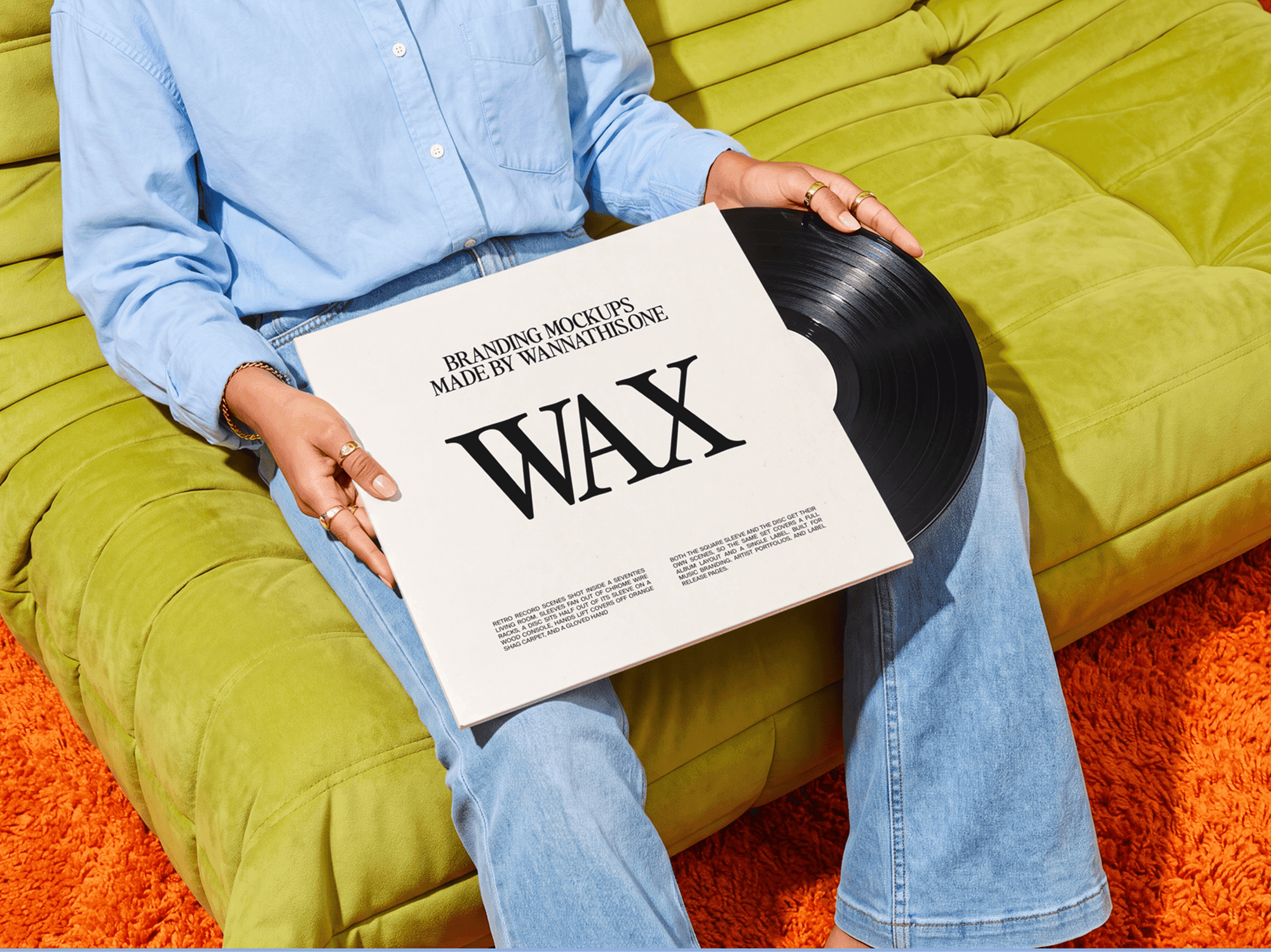 Person sitting on a sofa holding a vinyl record sleeve on their lap
