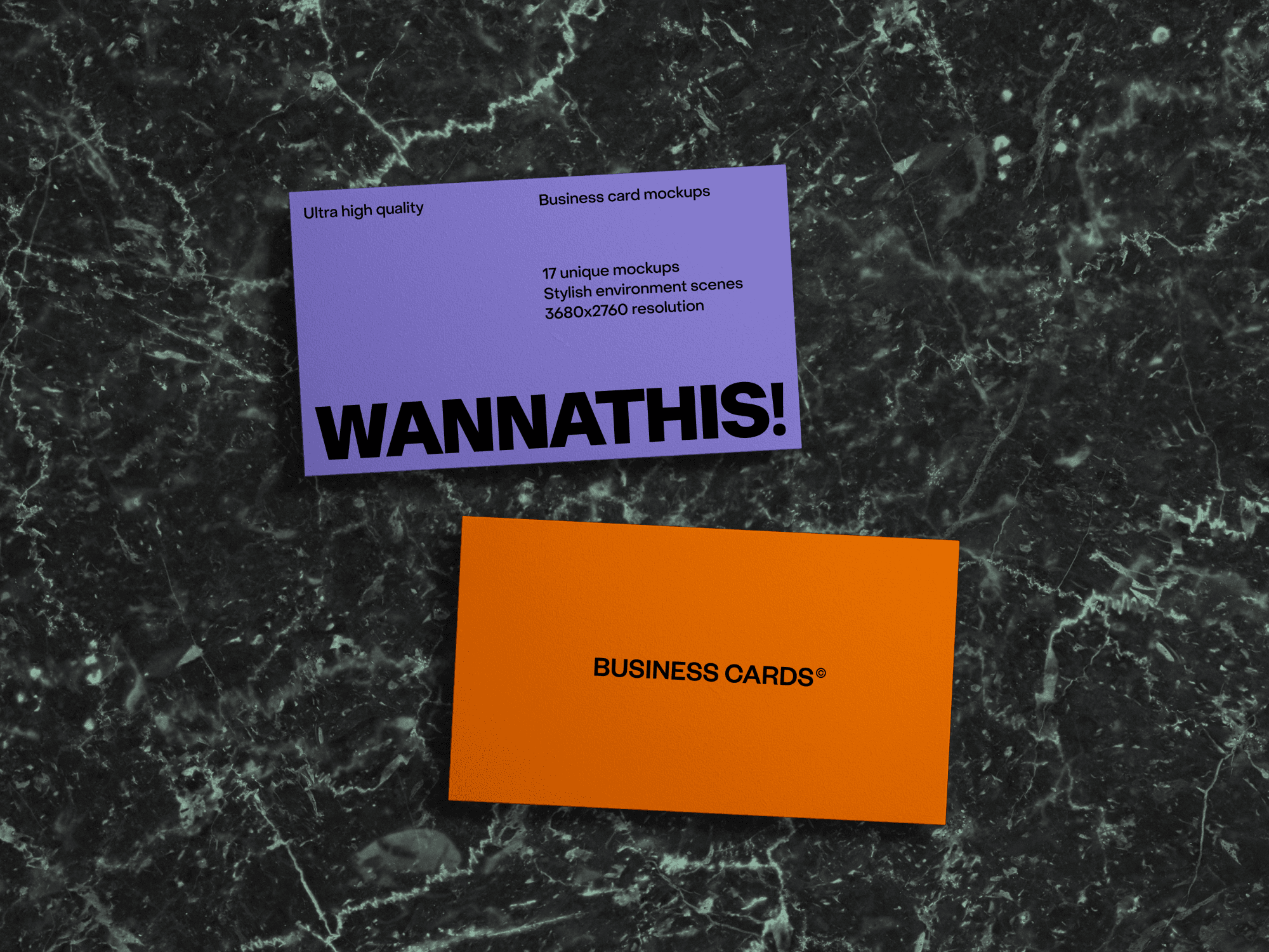 Two business cards placed on a dark marble surface.