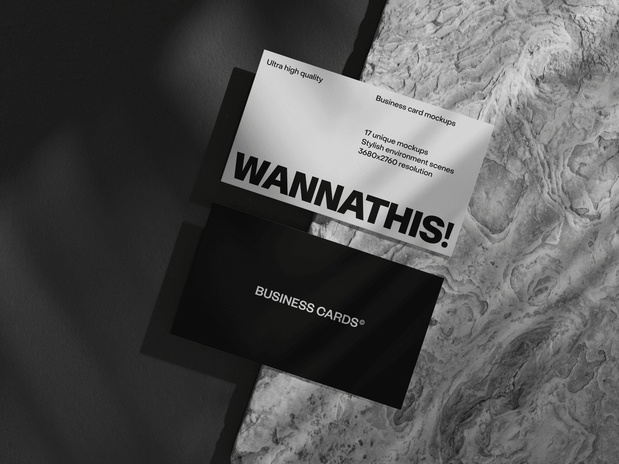 A modern business card mockup resting on a textured stone surface.