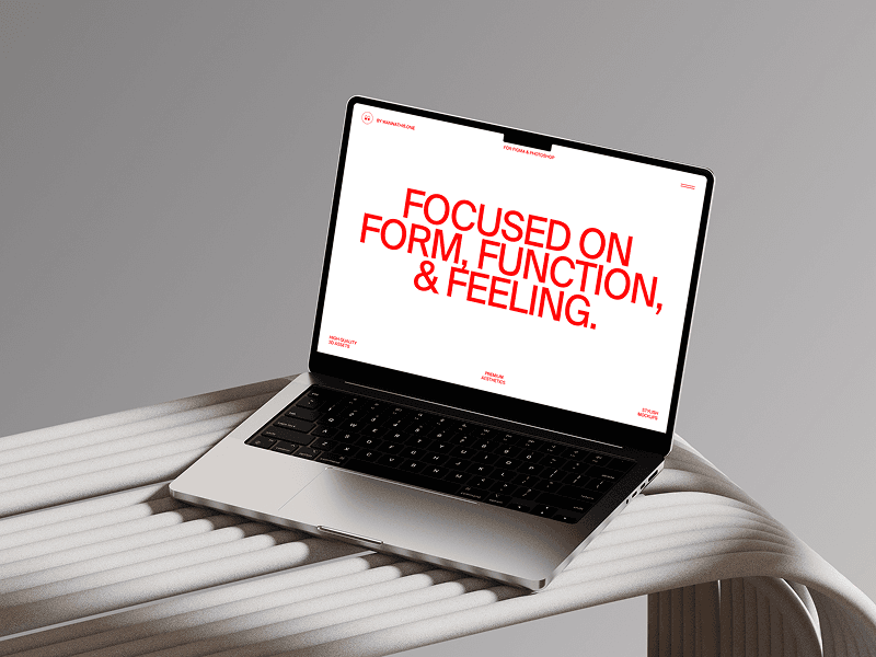 MacBook mockup positioned on a ribbed white tabletop in soft light