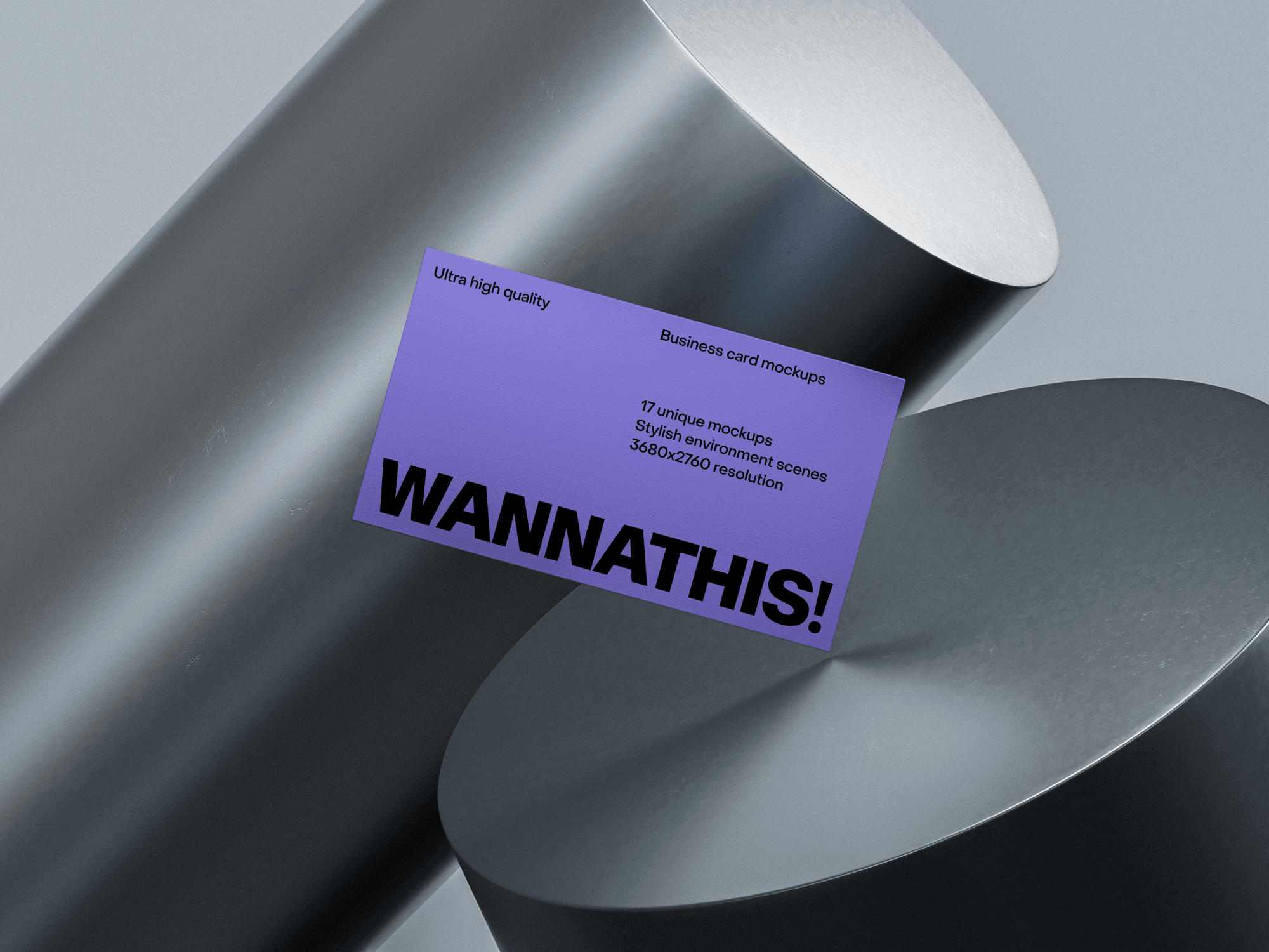 A premium business card mockup placed on two large metallic cylinders.