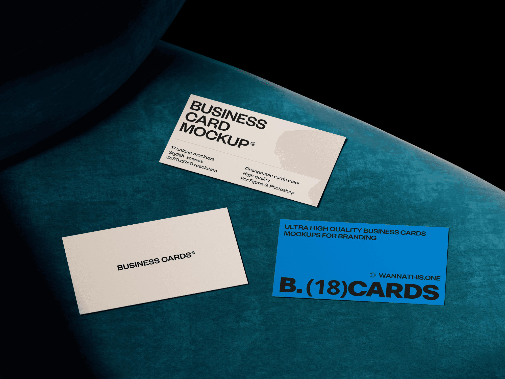 Three business cards laid out on a teal chair