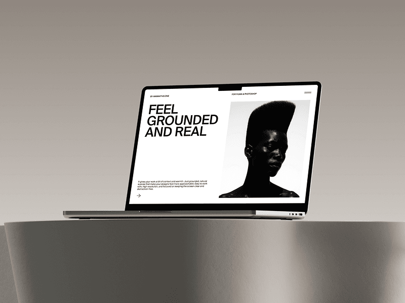 MacBook placed flat on a beige curved table in warm tones