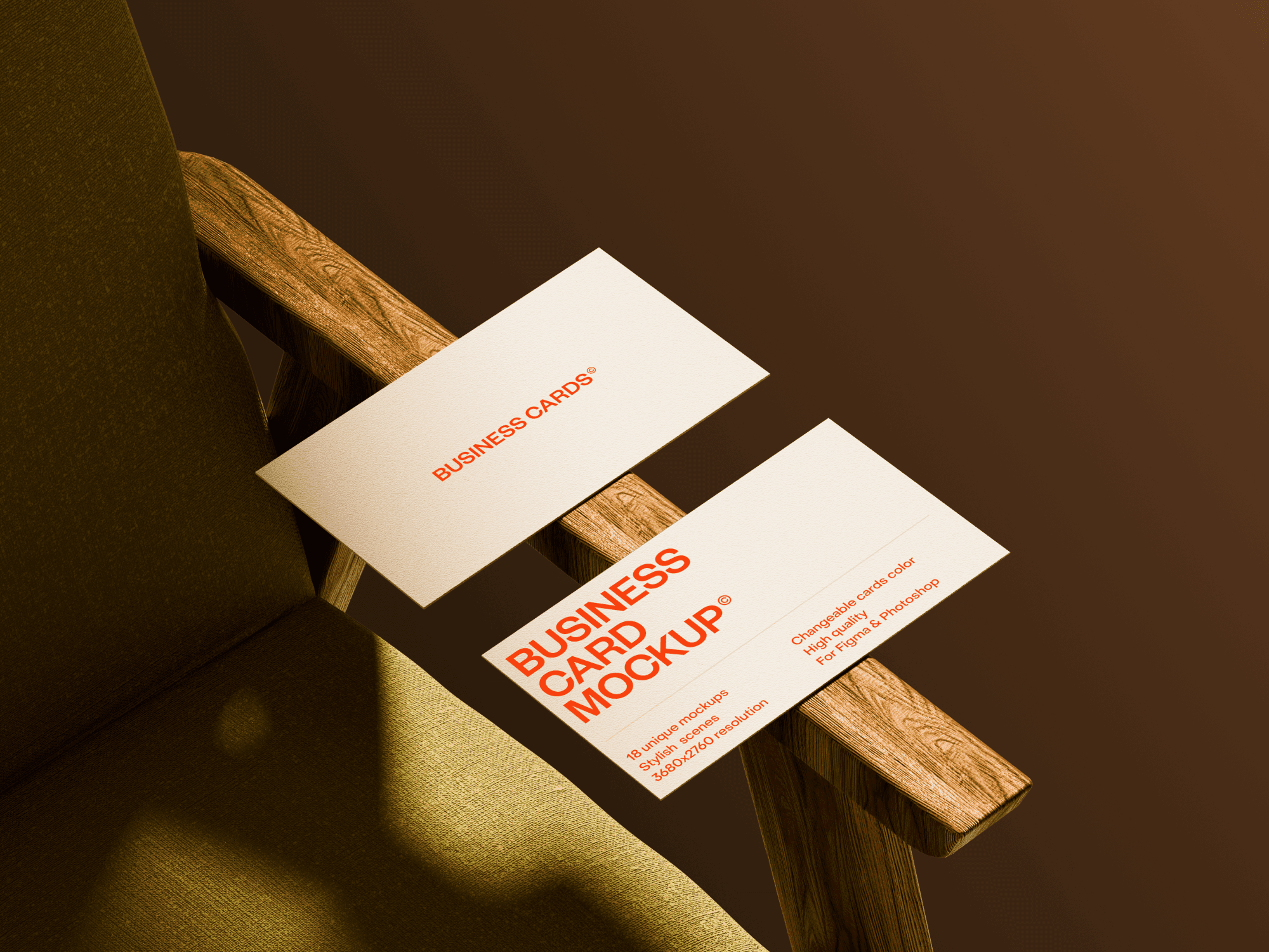Business card mockup placed on a wooden chair armrest with a green fabric seat.