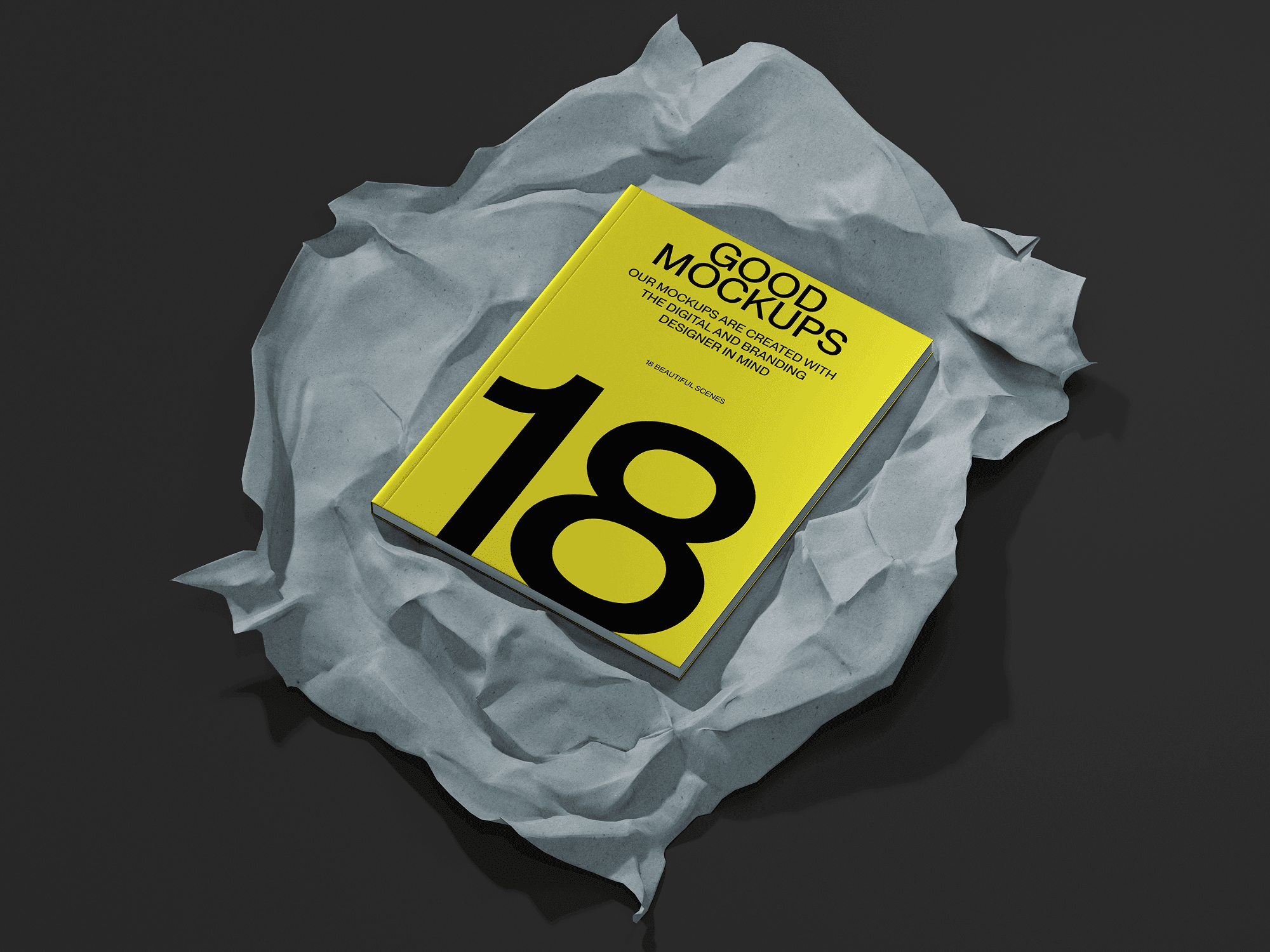 A yellow book mockup placed on crumpled gray paper with a dark, moody background