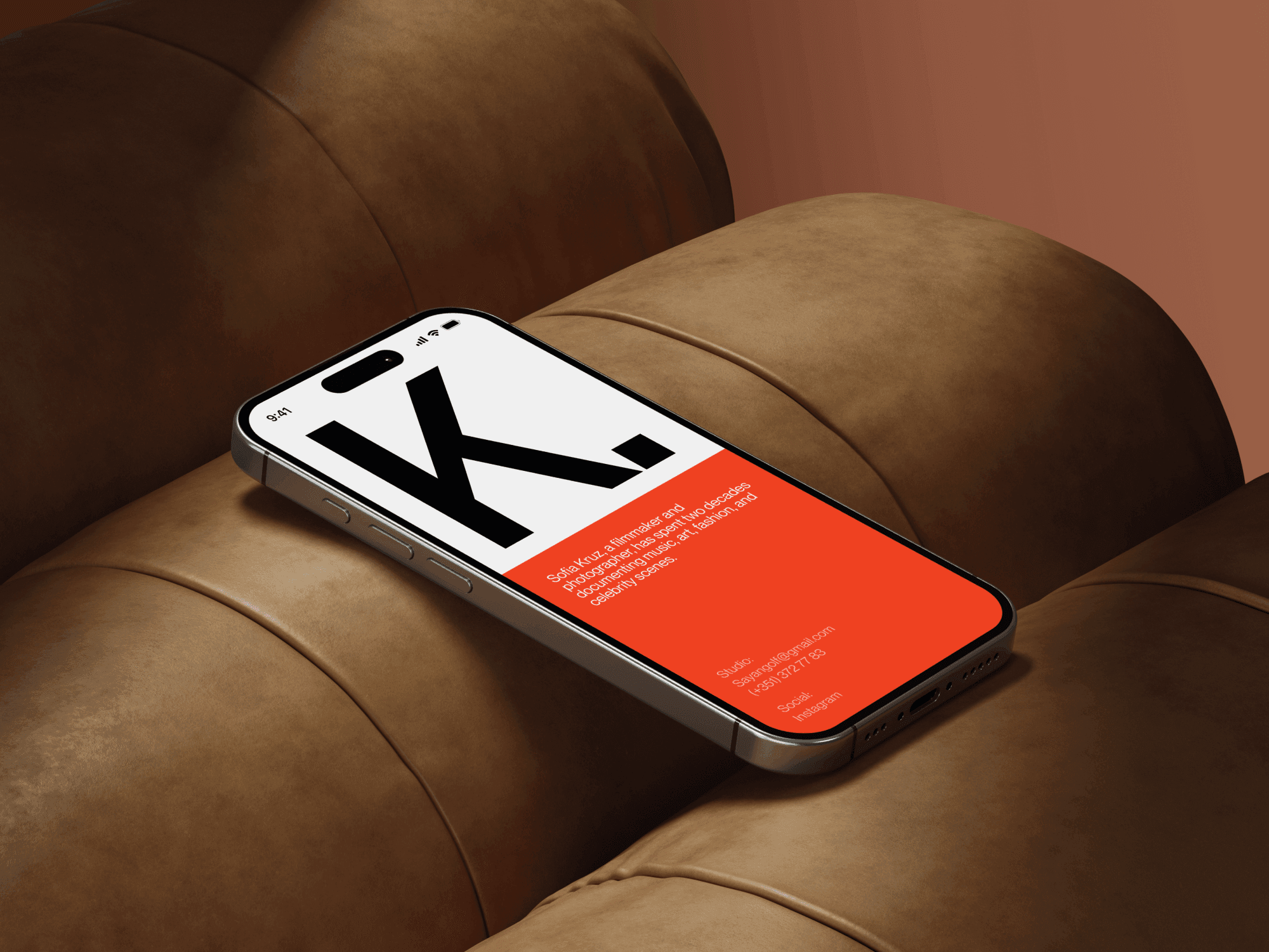 iPhone 16 mockup lying flat on a brown leather cushion.