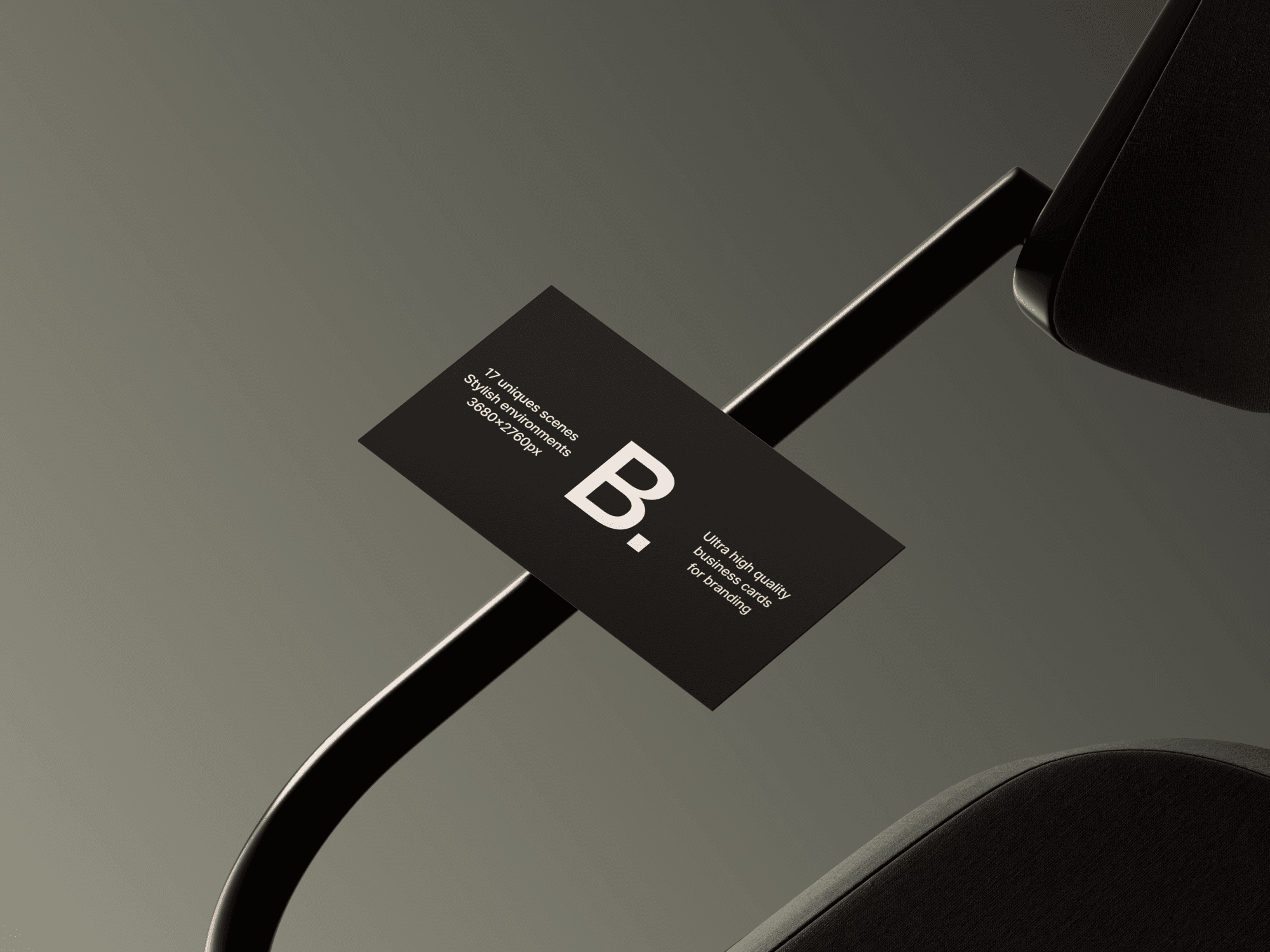 Dark business card mockup resting on a black metal chair frame.