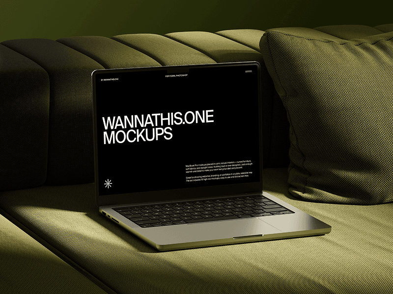 MacBook mockup placed on green velvet sofa arm in dramatic lighting