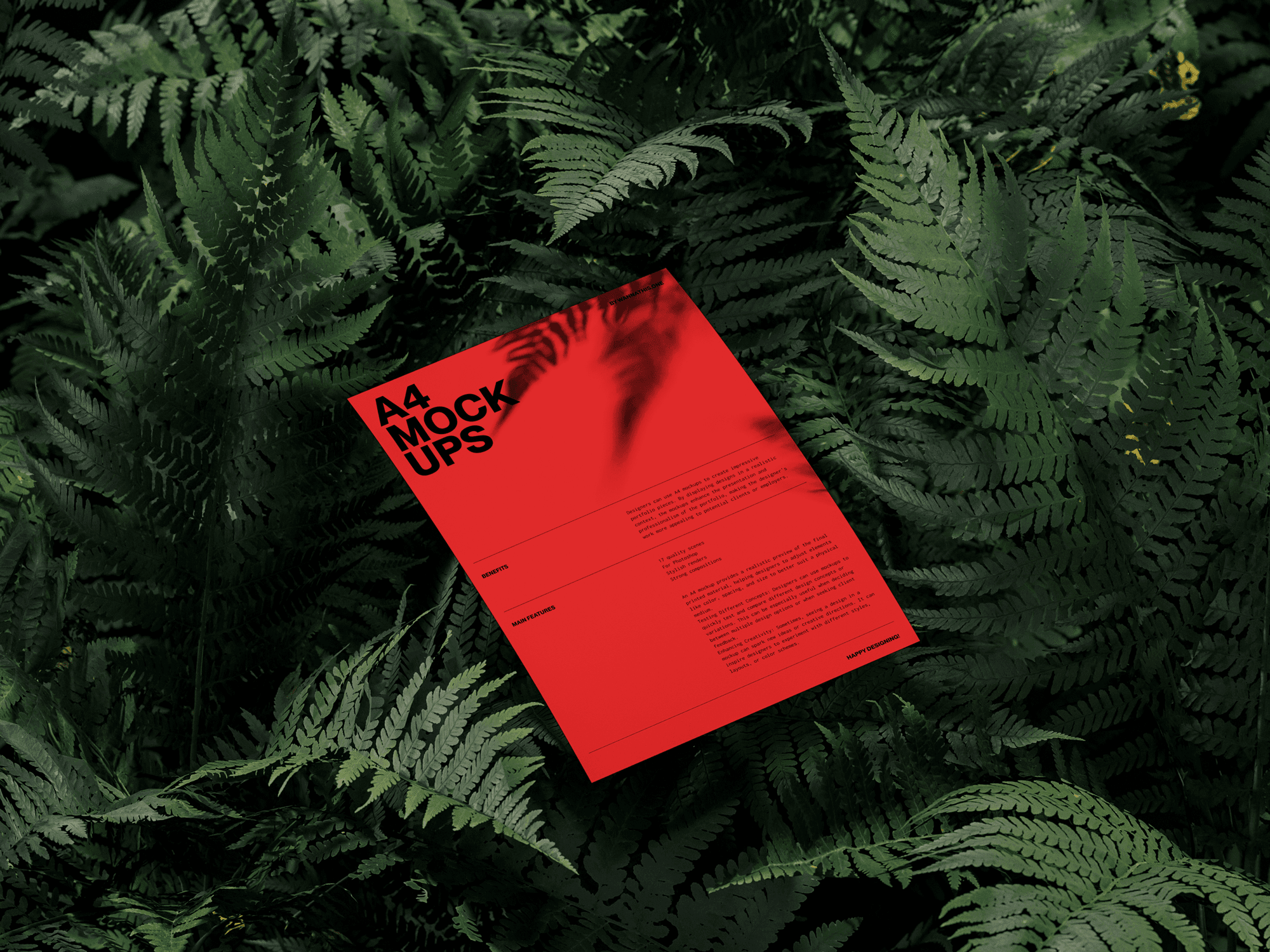 A red A4 paper mockup placed among vibrant green ferns, creating a striking contrast.