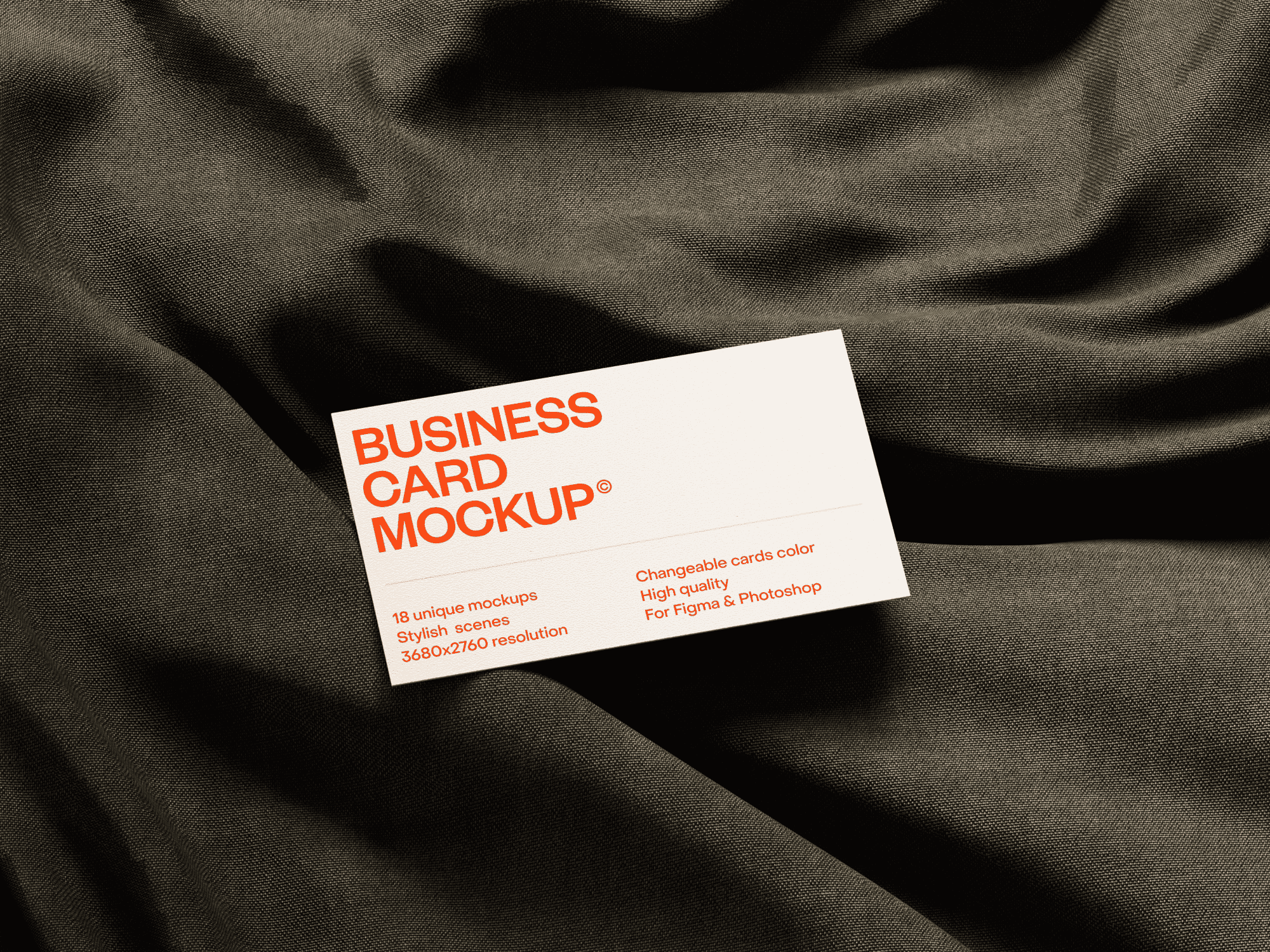 Business card mockup lying on textured fabric with soft shadows.