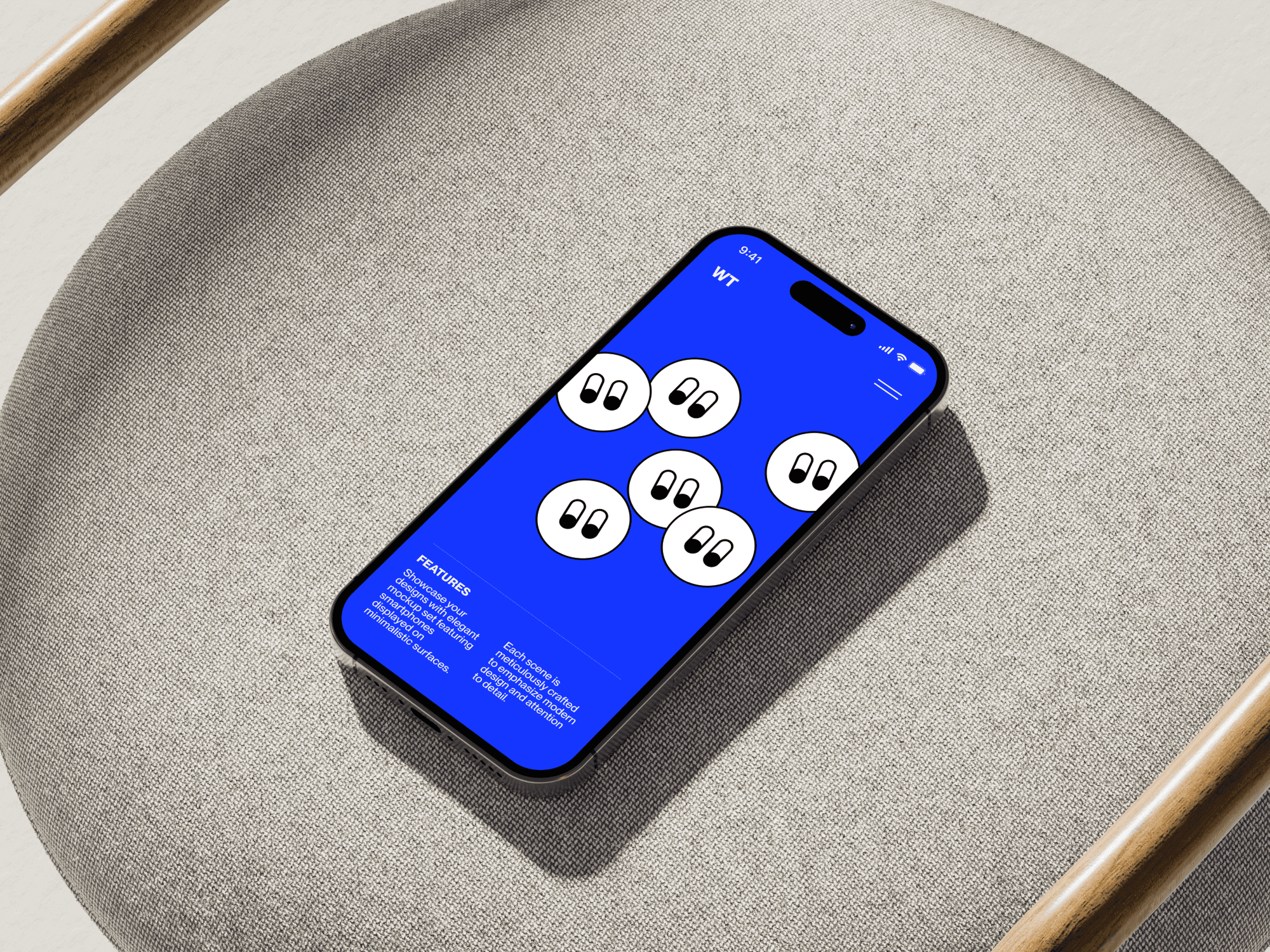 iPhone 16 mockup on a textured gray chair with a wooden accent.