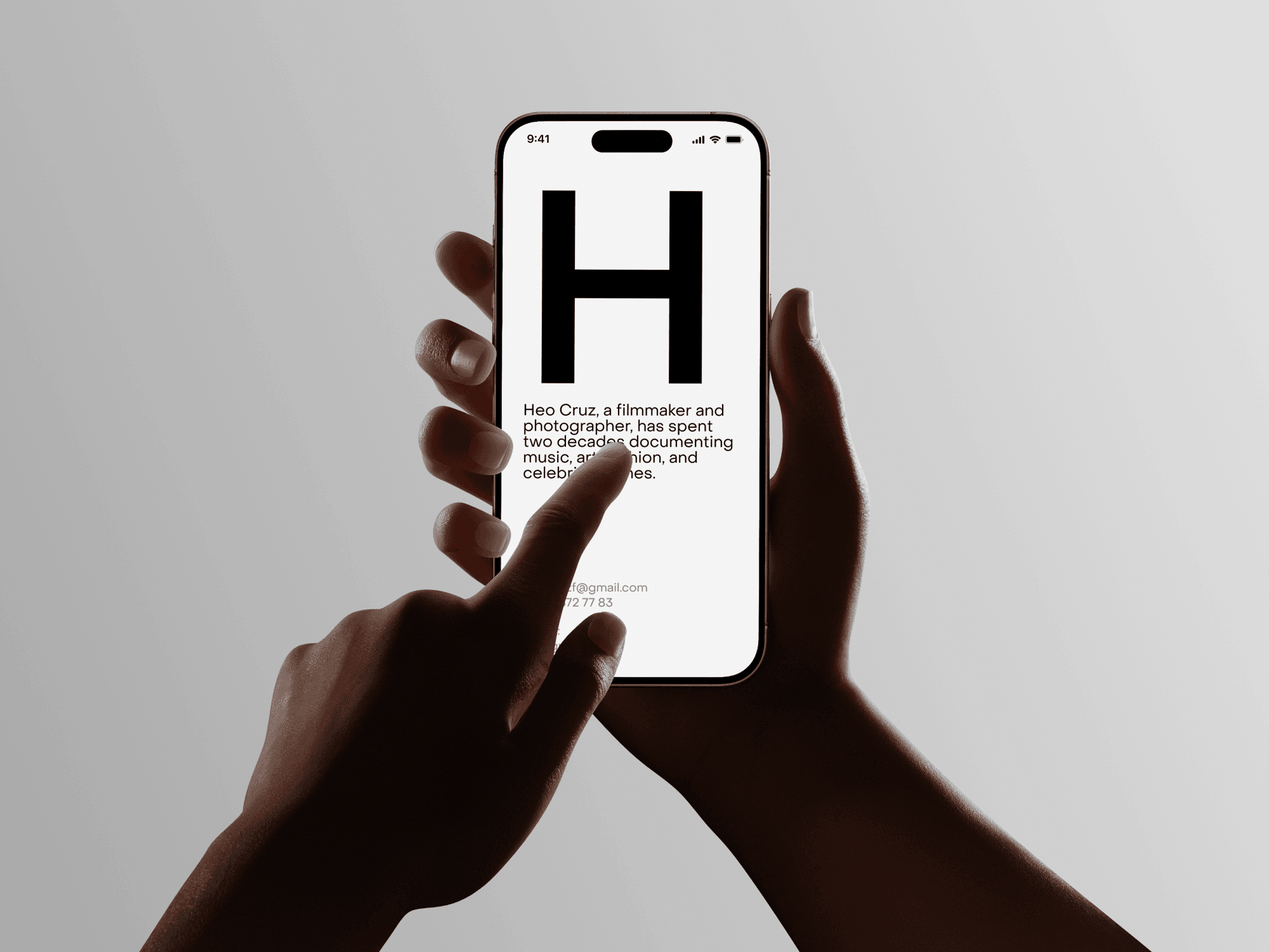 Two hands holding an iPhone with a white background in a studio setting