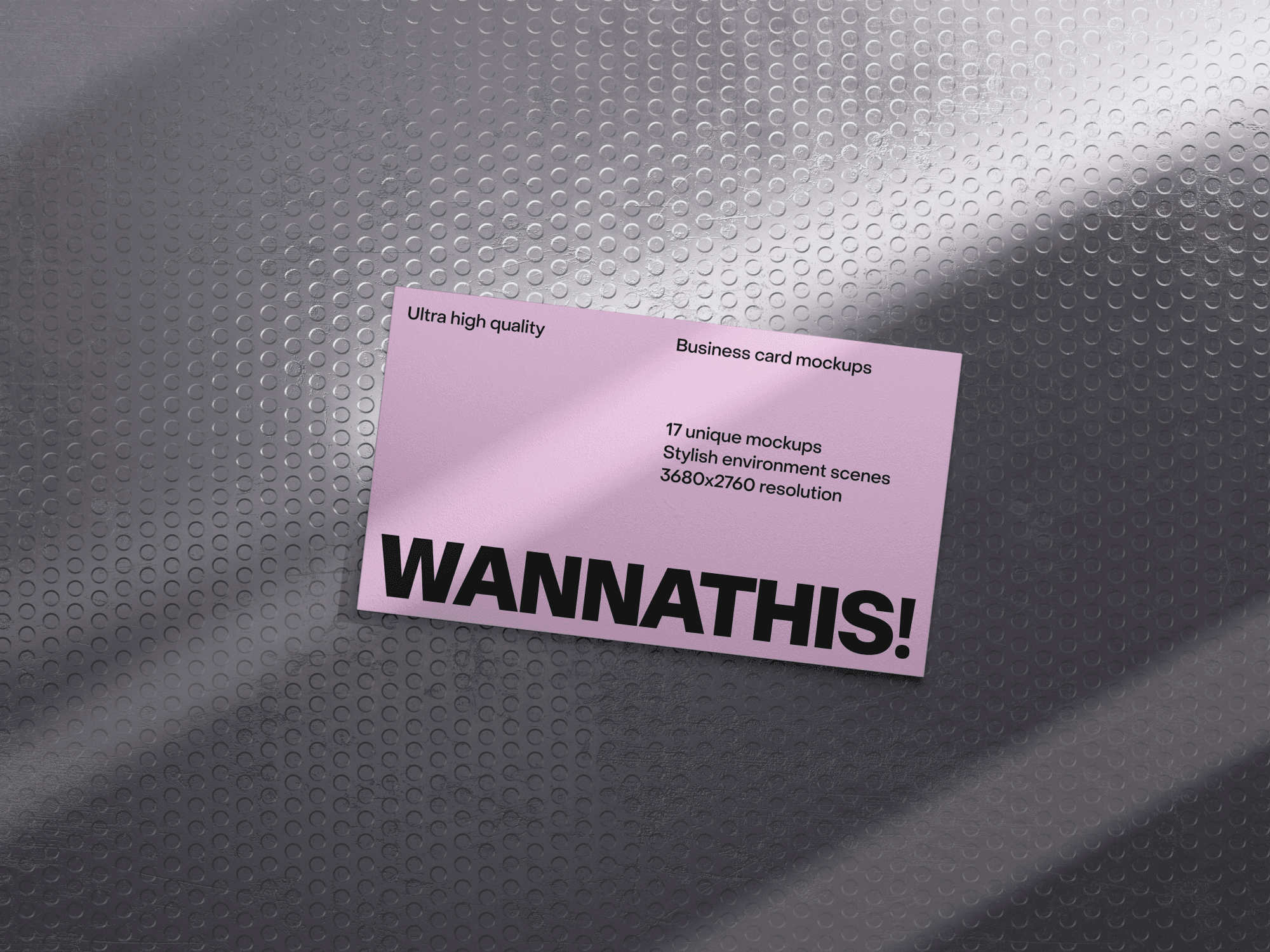 Pink business card mockup on a textured metallic surface.