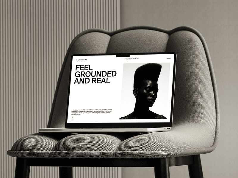 MacBook mockup resting on modern white upholstered curved chair