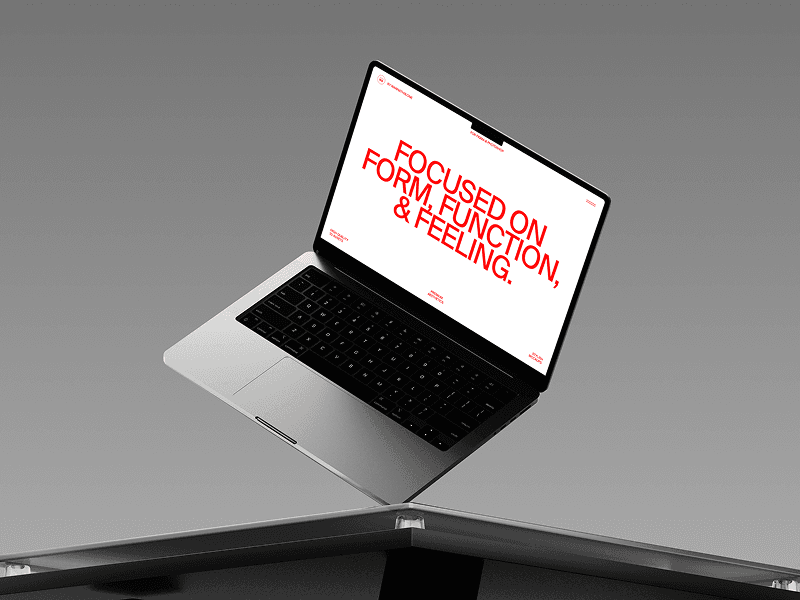 Floating MacBook mockup angled on light grey seamless background