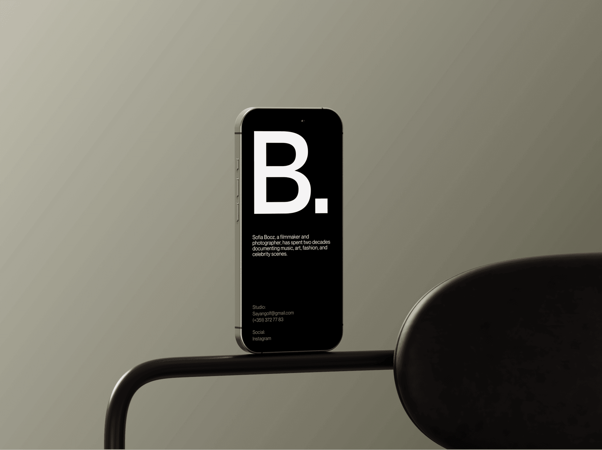 iPhone 16 mockup standing upright on a black metal armrest.