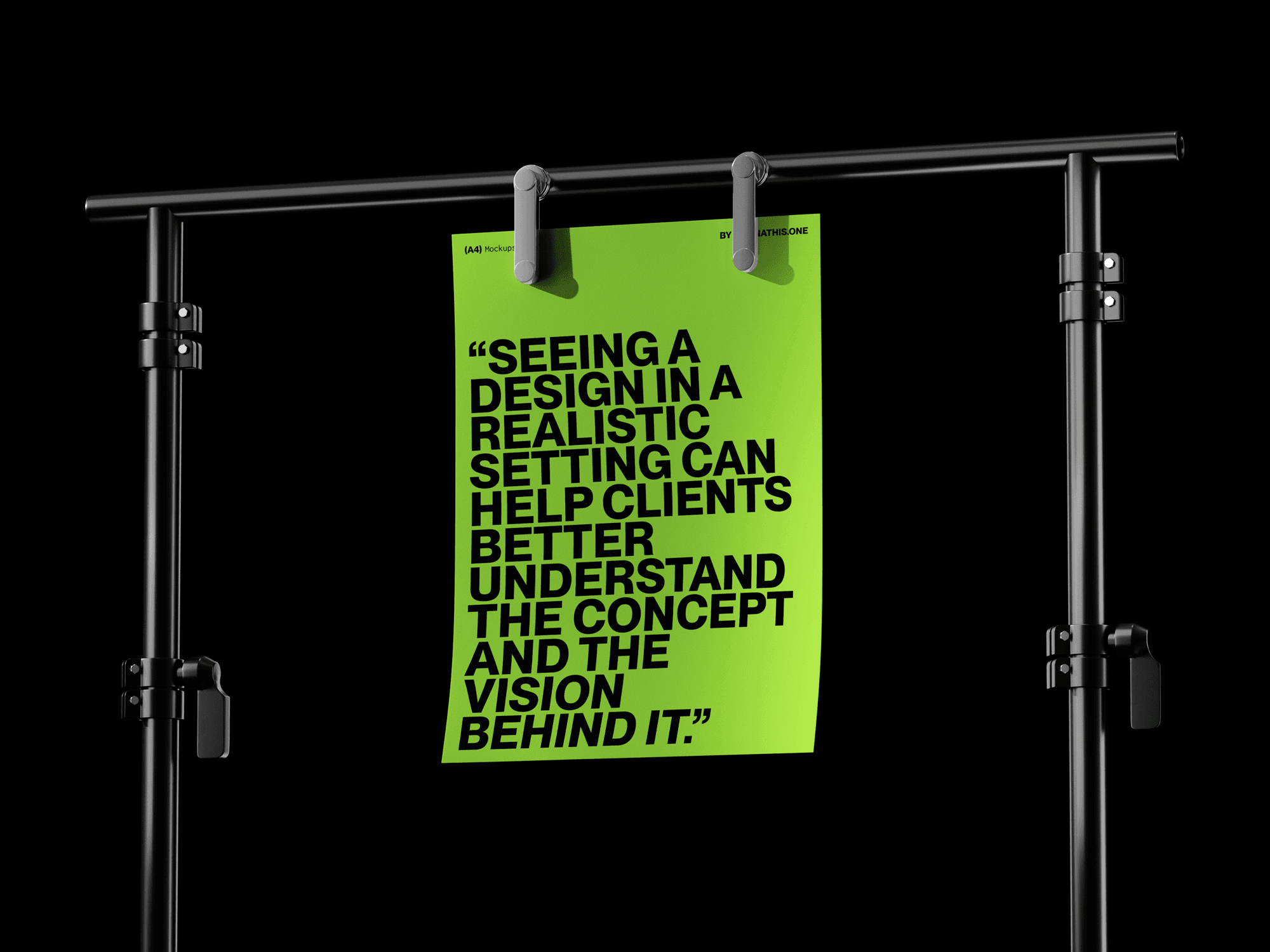 A green A4 poster with bold typography hanging on a professional studio stand.