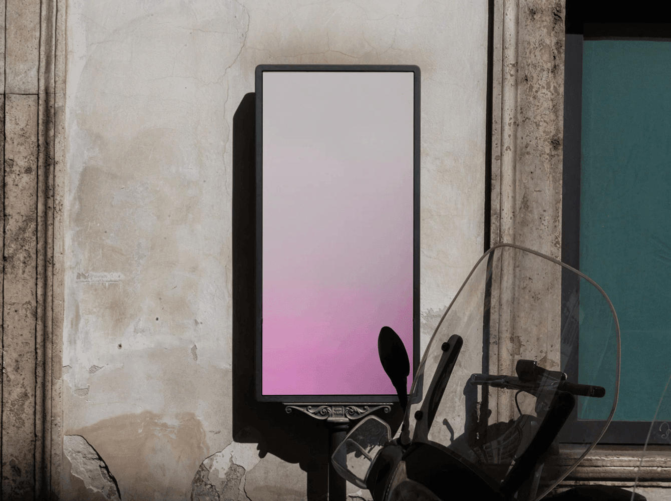 Vertical street billboard mockup beside scooter and old wall