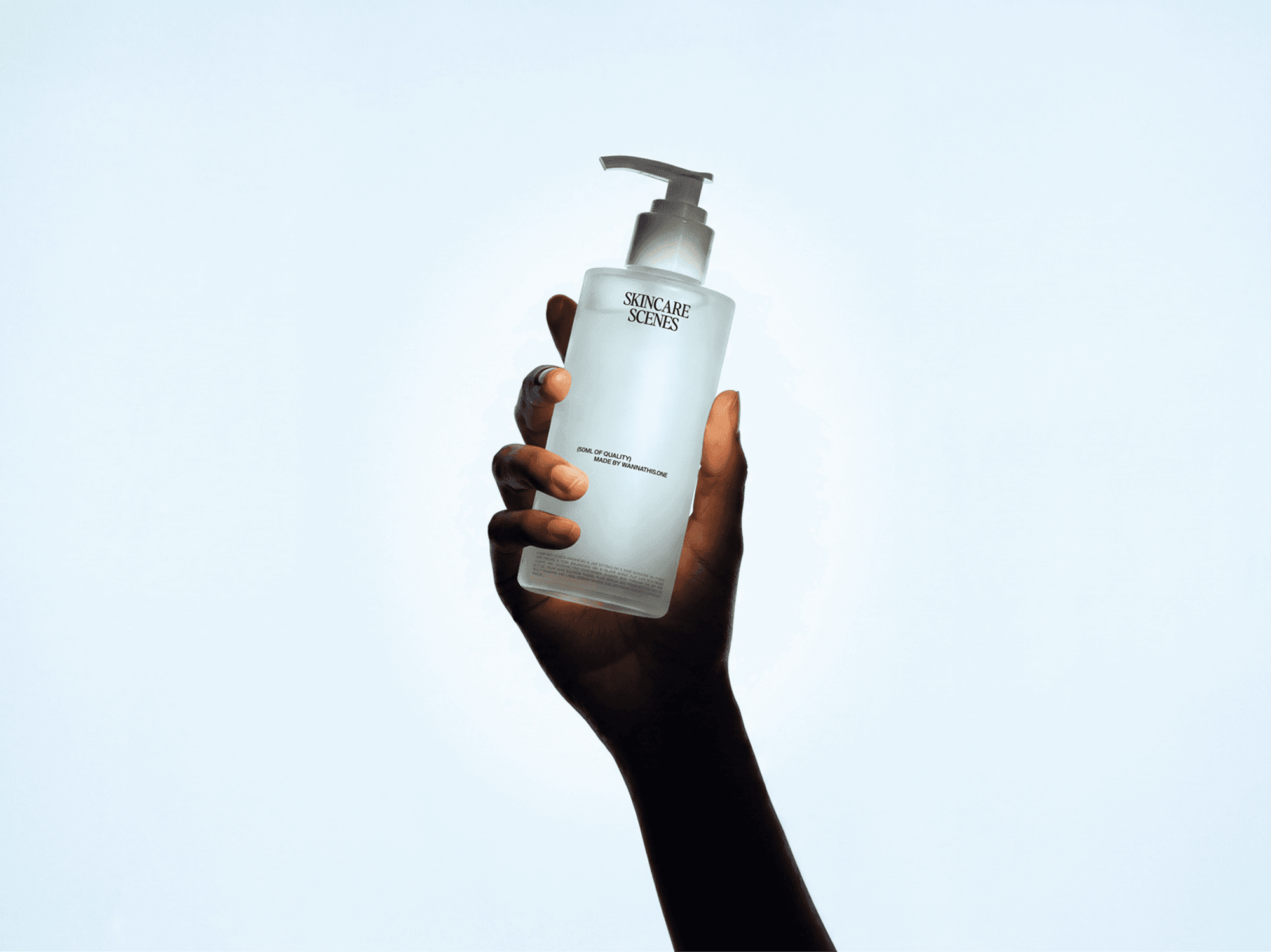 Hand holding a skincare pump bottle mockup against a clean refined background in a minimal beauty studio scene