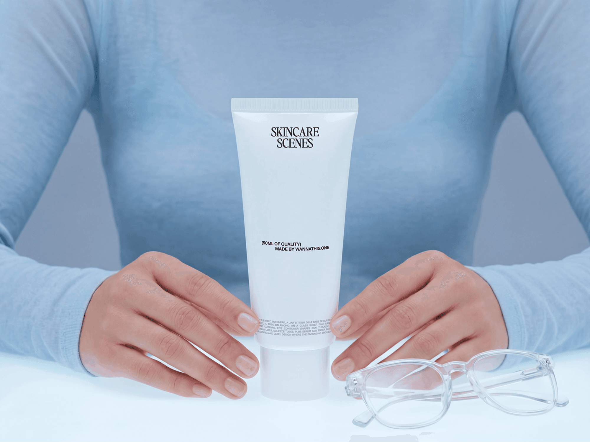 Skincare tube mockup held with both hands on a clean refined surface in a minimal beauty studio scene