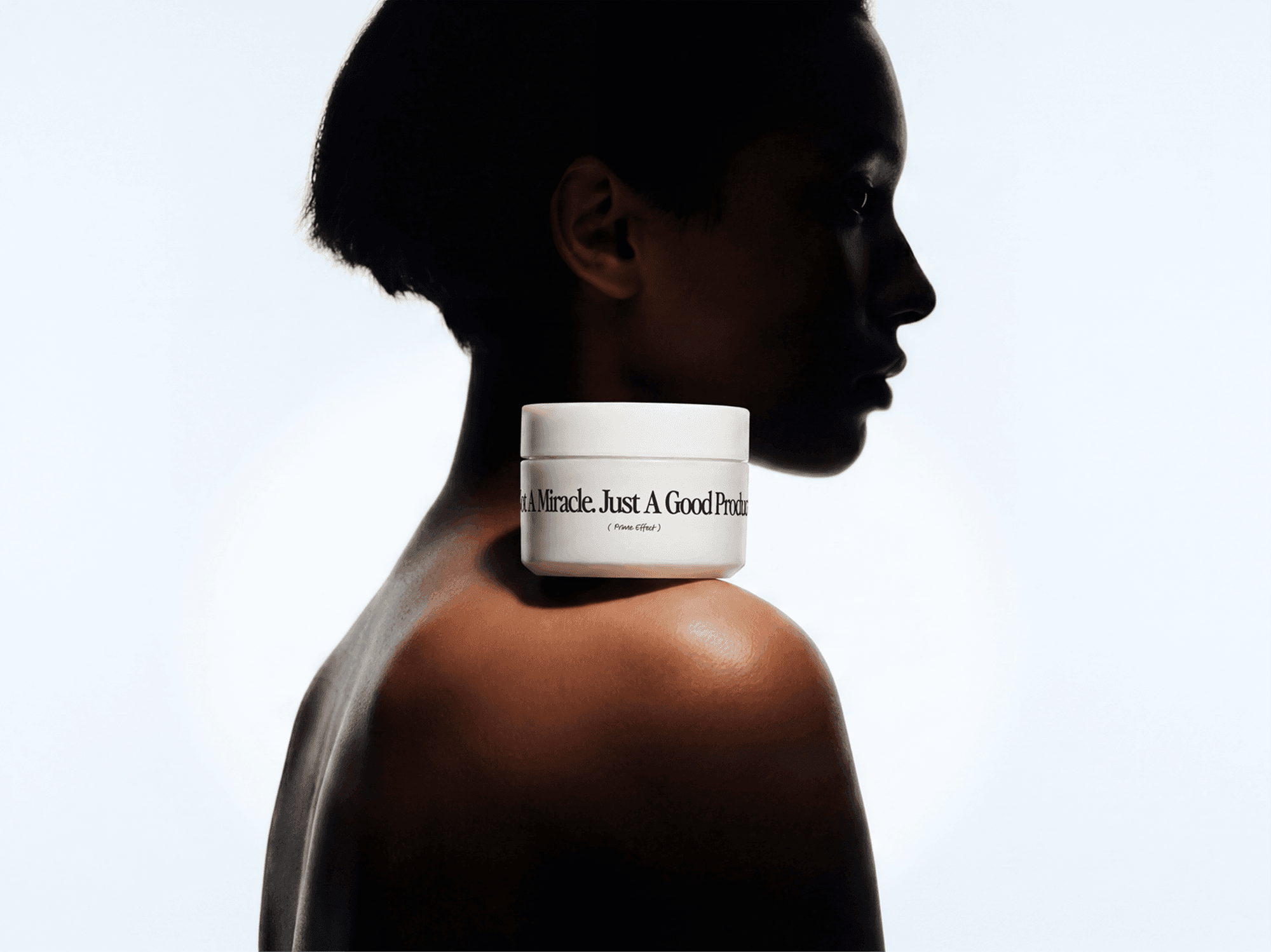 Skincare cream jar mockup balanced on a person's shoulder in a refined beauty portrait studio scene