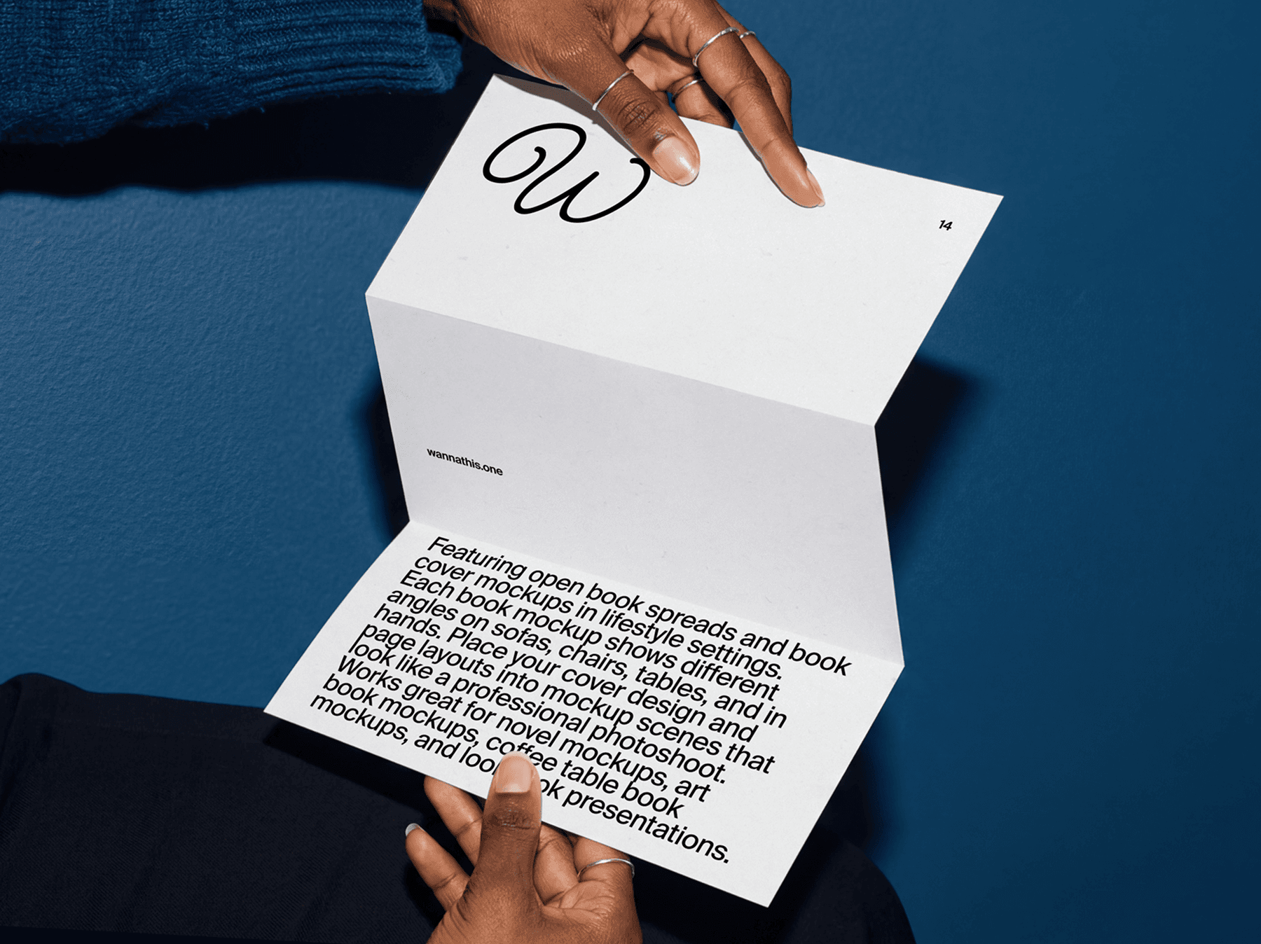 Hands flipping through pages of a softcover book