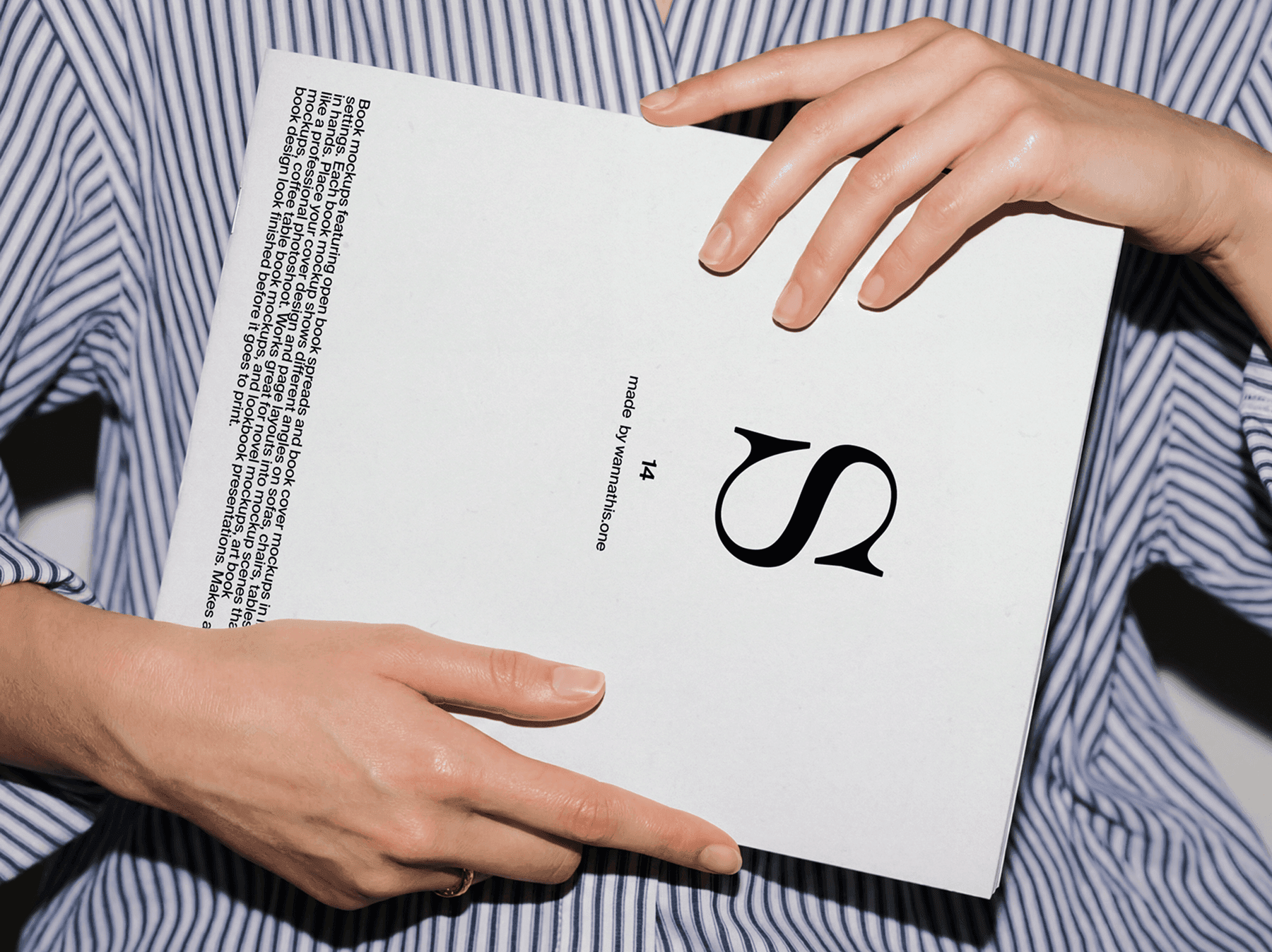 Close-up of hands holding a softcover book in a casual setting