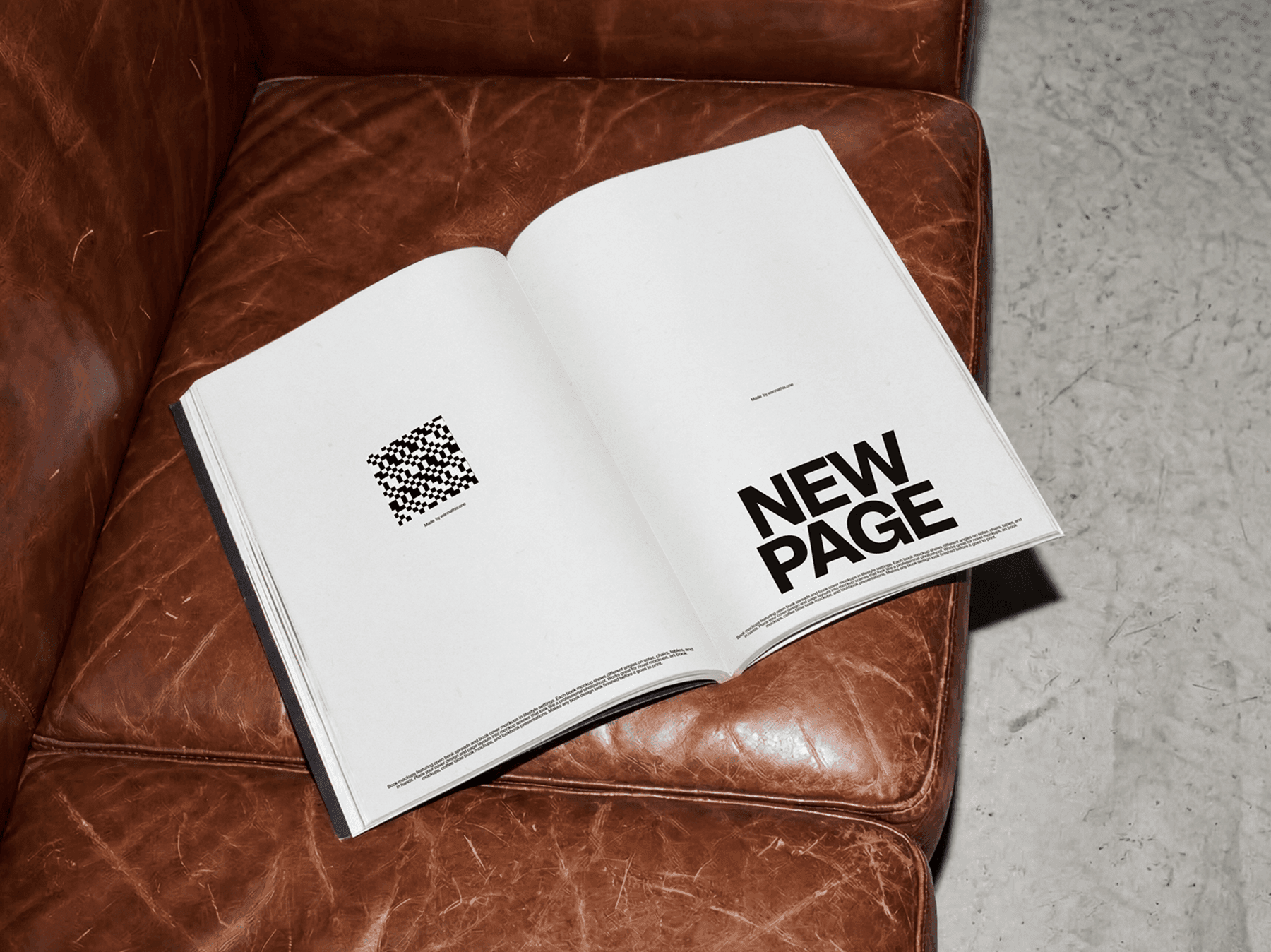 Open softcover book placed on a sofa seat in a relaxed interior