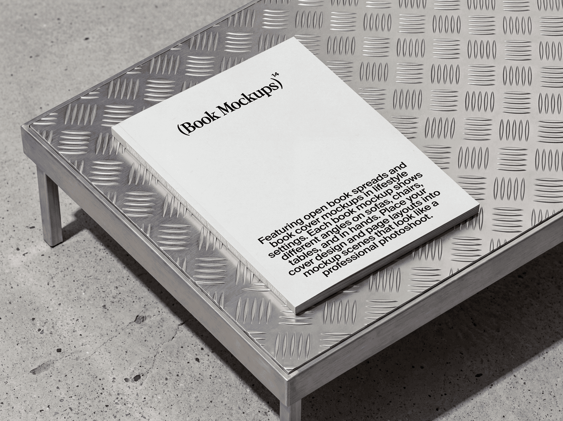Softcover book placed on a metal table surface in a minimal setup