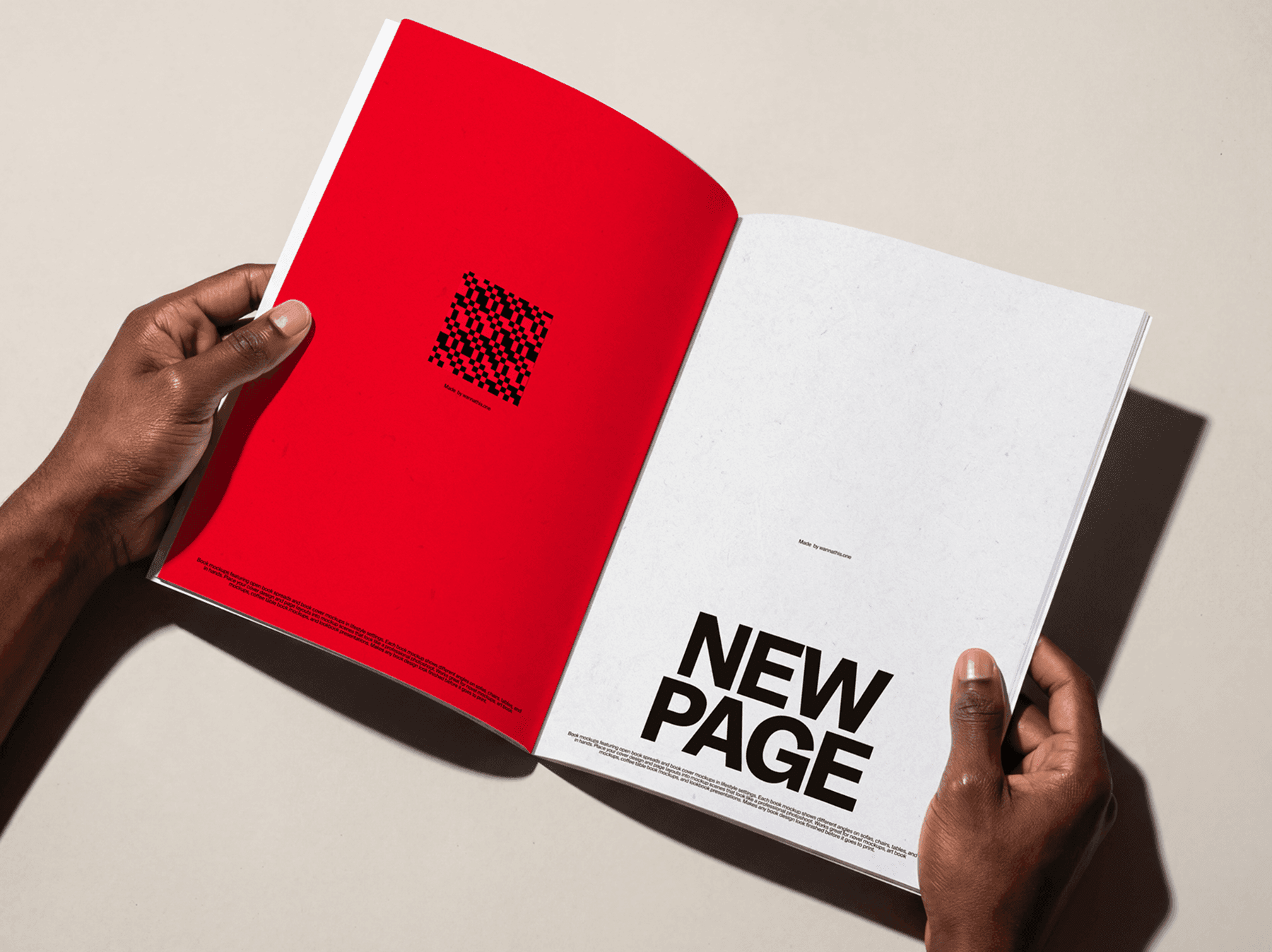 Hands holding an open softcover book showing inner pages