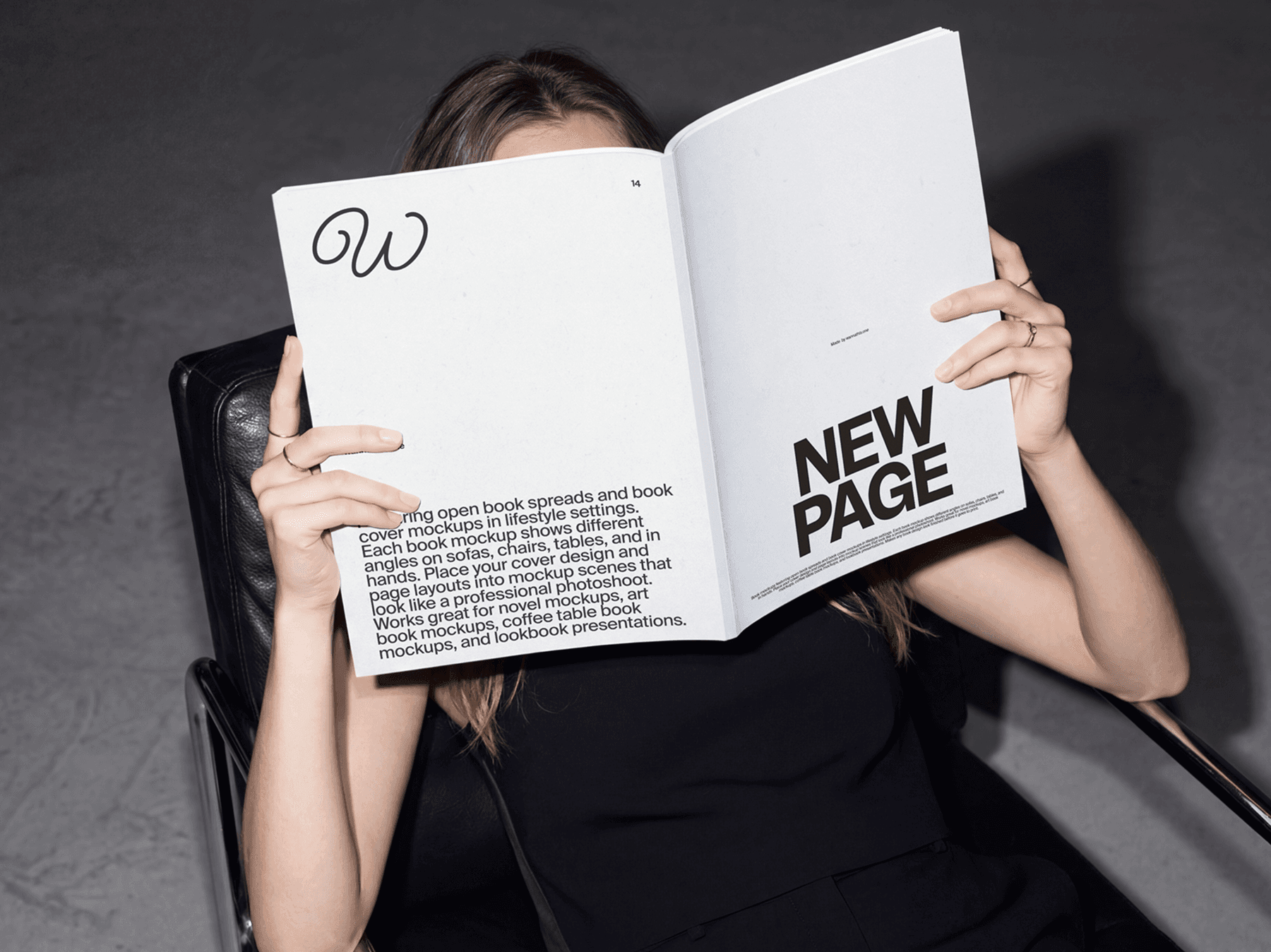 Person holding and reading an open softcover book