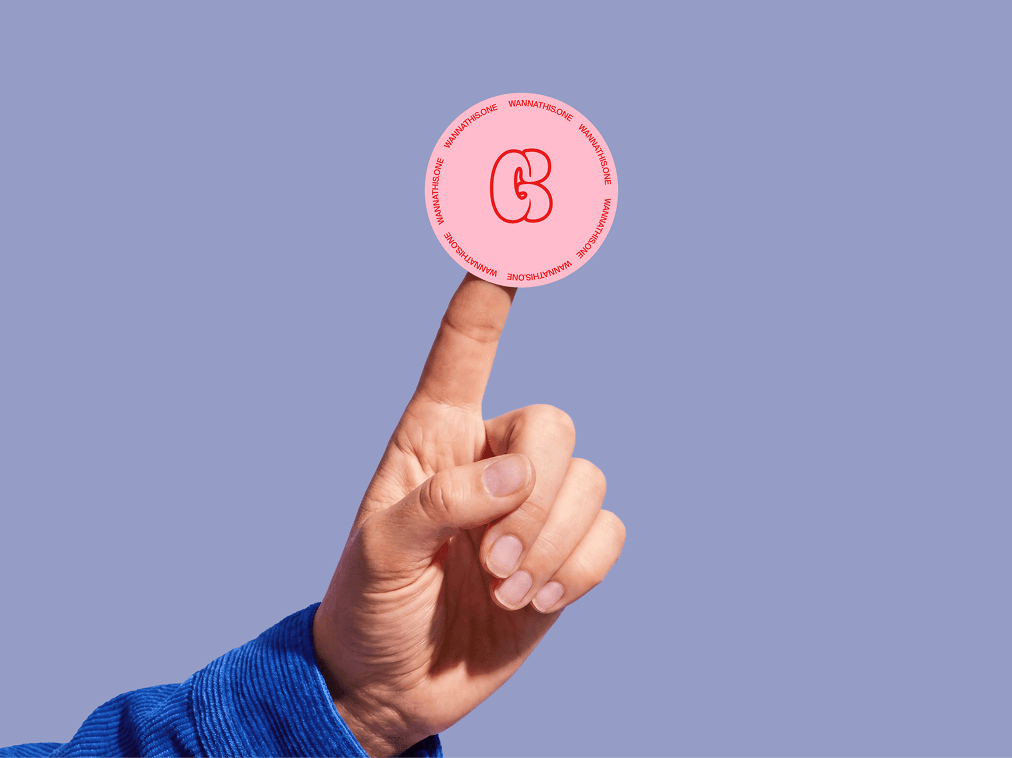 Round sticker mockup balanced on a fingertip in a playful creative studio composition scene