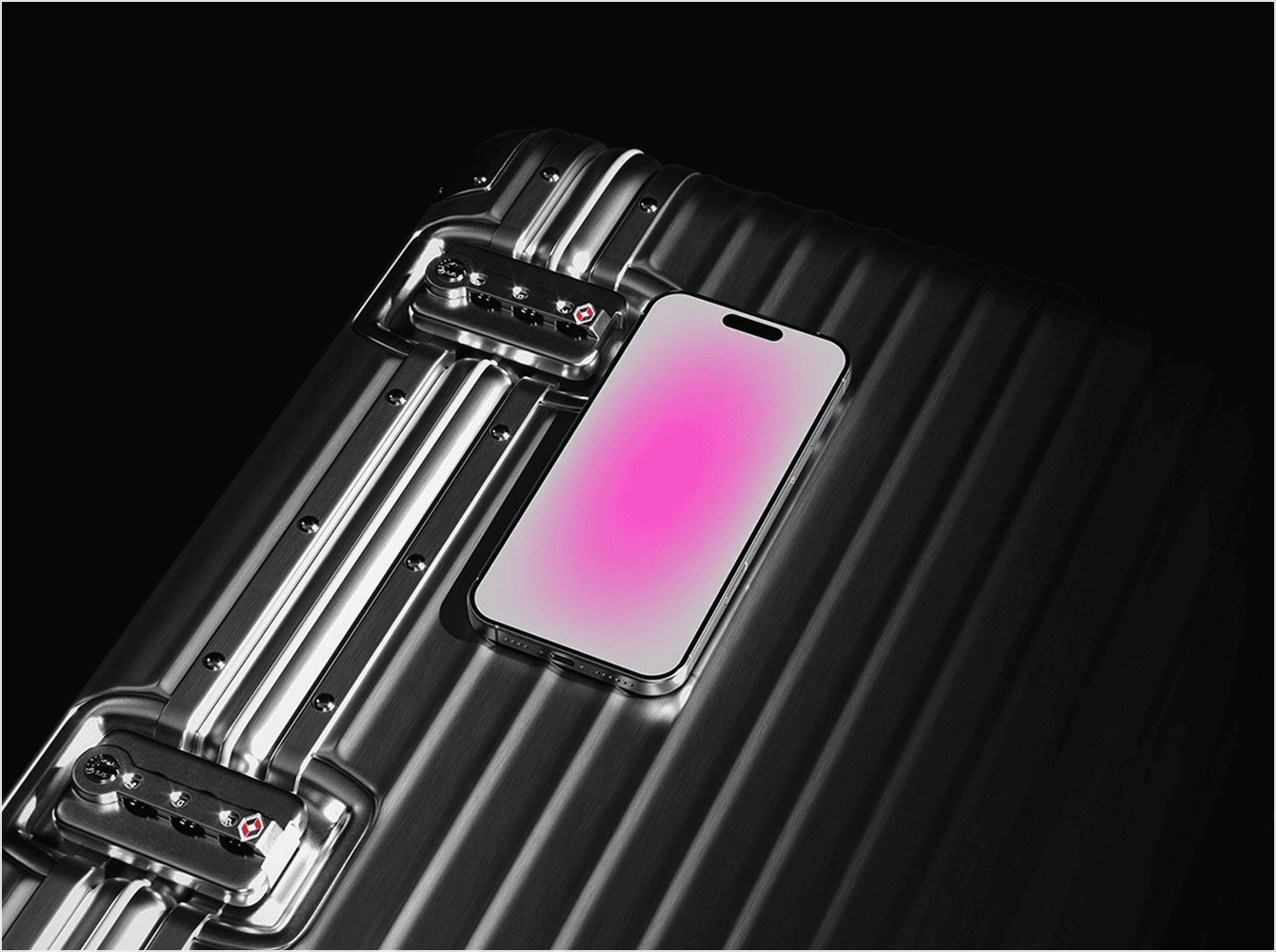 Modern iPhone 16 Pro Max mockup with pink gradient screen placed on top of a sleek black aluminum suitcase with metal locks