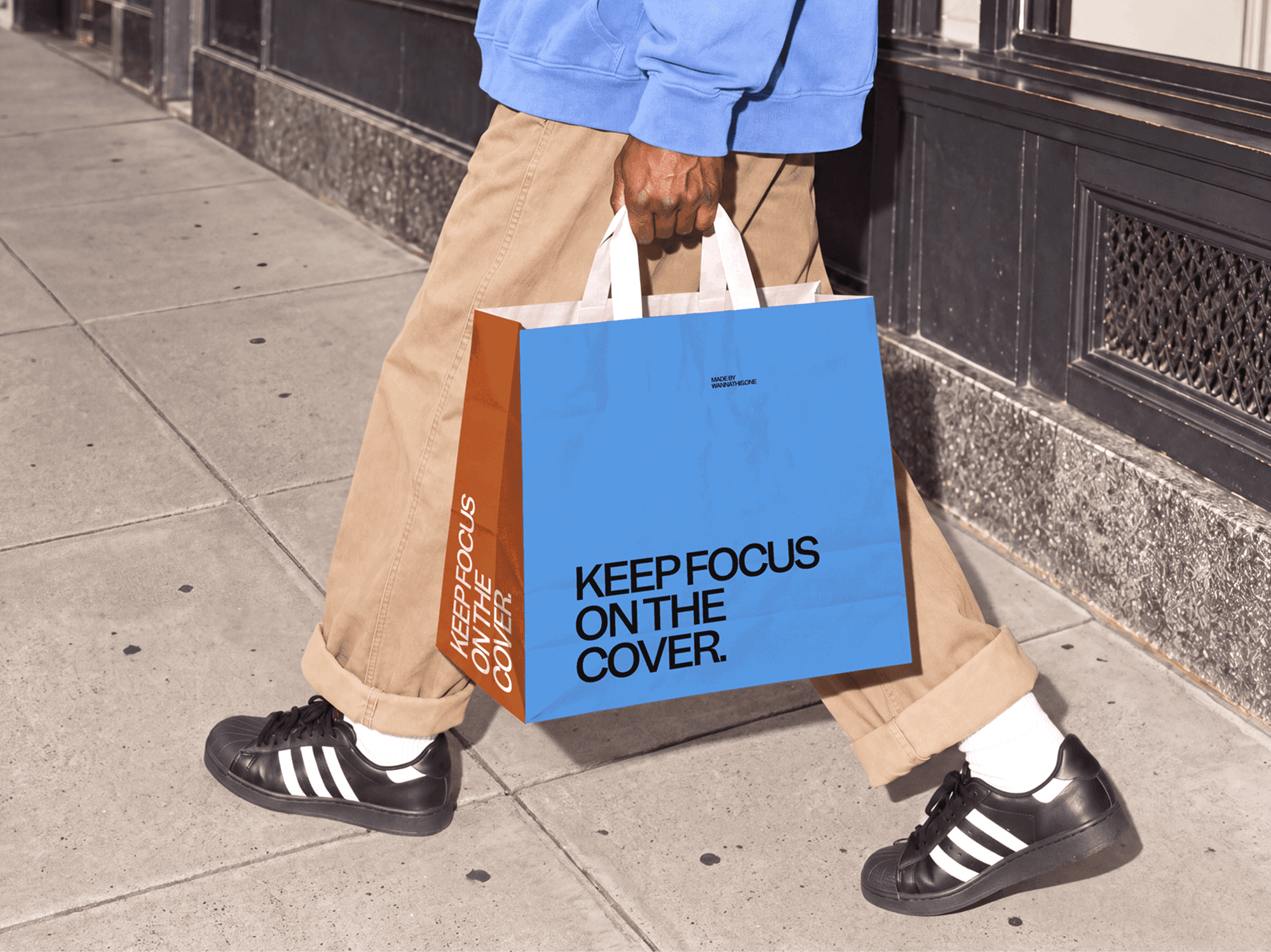 Paper shopping bag mockup with twisted handles carried along a city pavement