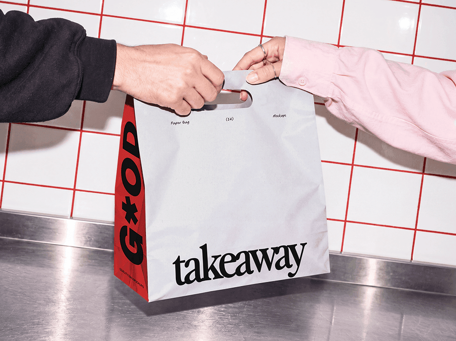 Takeaway paper bag mockup passing between two pairs of hands over a metal counter