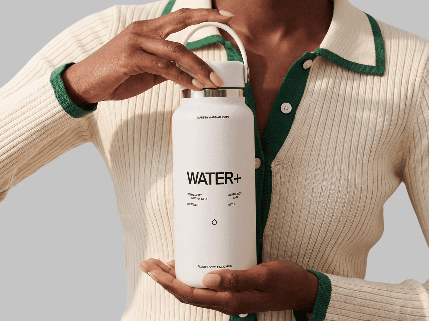 Travel bottle mockup presented with both hands by a person in a clean refined product studio scene