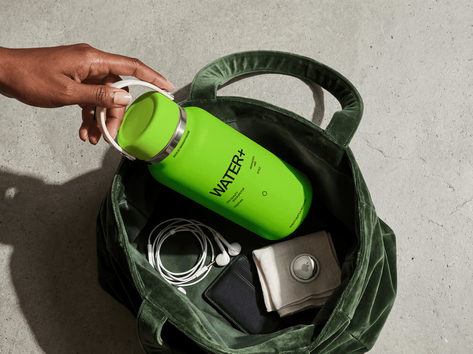 Travel bottle mockup tucked inside a refined tote bag with refined everyday items in casual lifestyle scene
